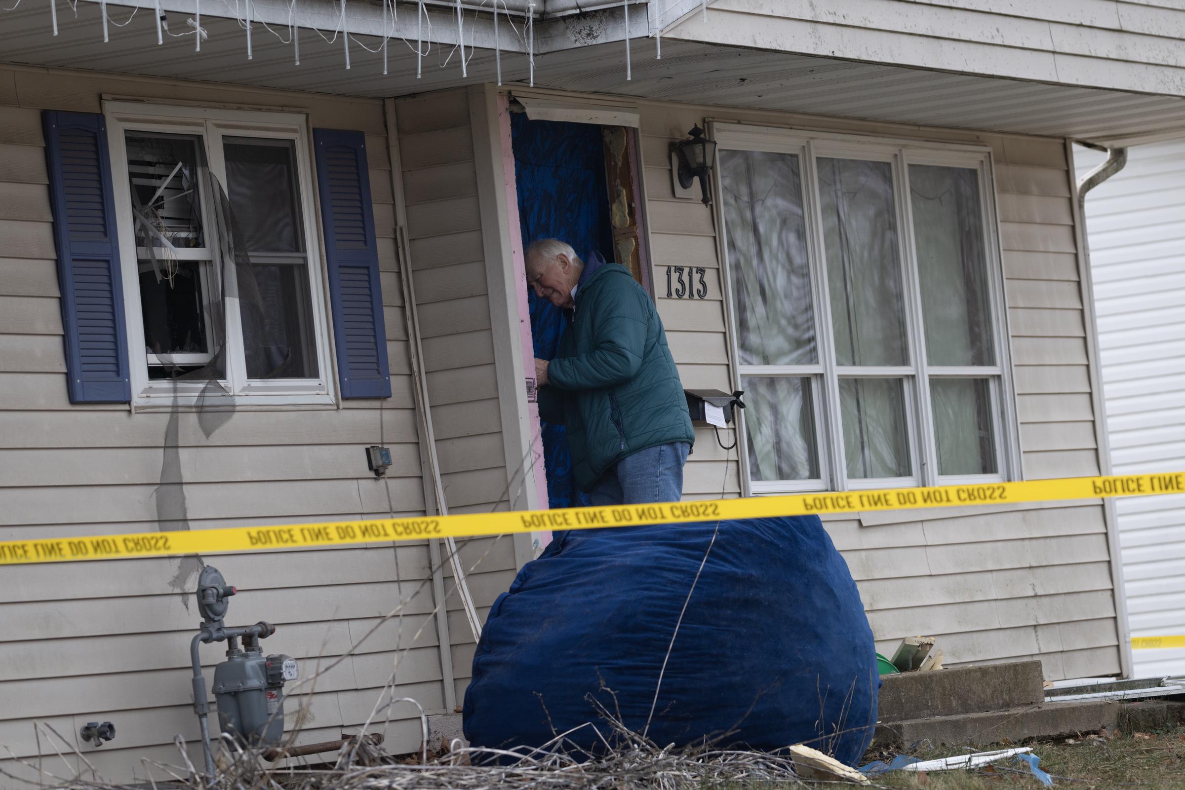 Workers repair the Madison home of 15-year-old Natalie Rupnow after police damaged it during an entry on December 17, 2024 | Source: Getty Images