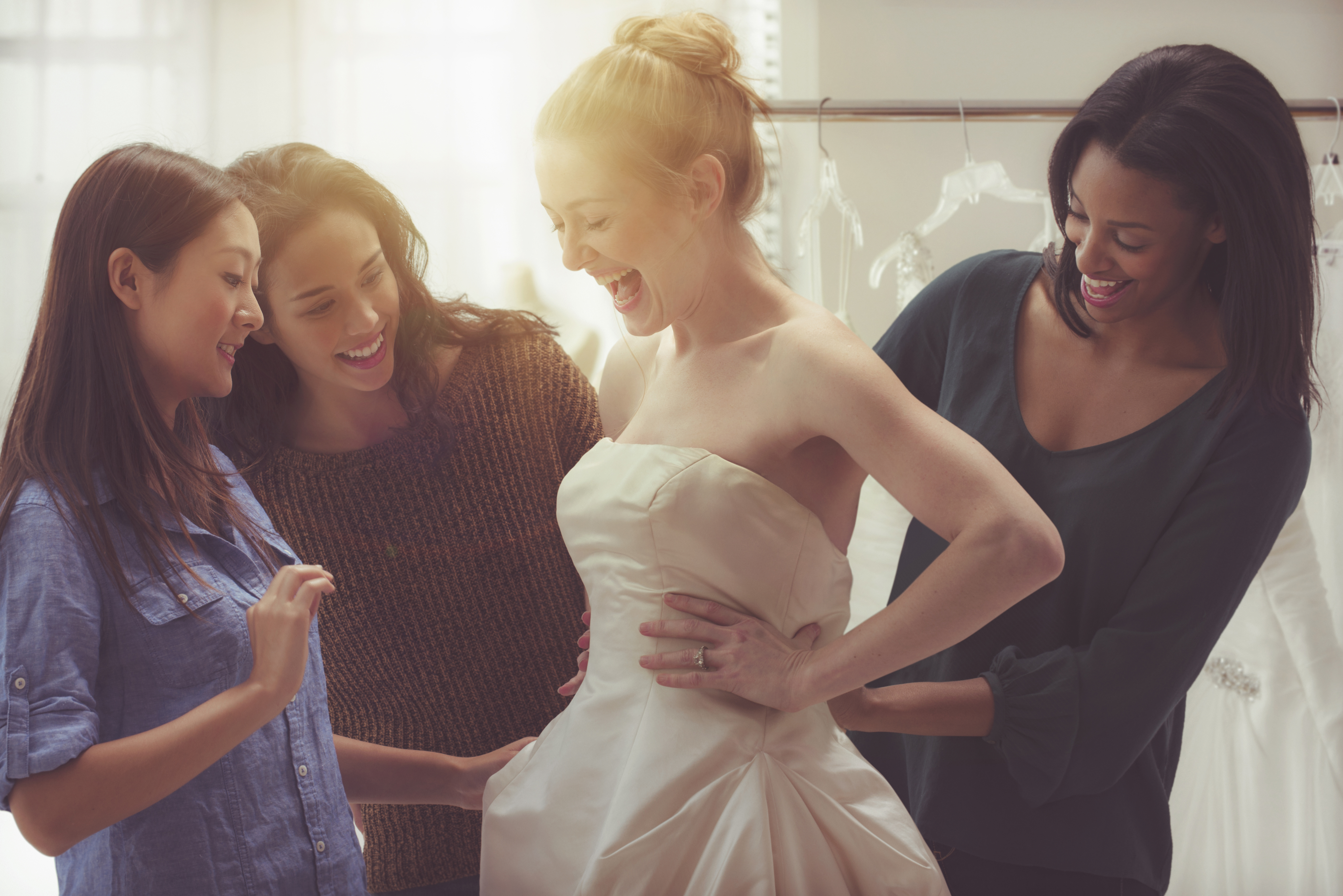 A bride and friends shopping for wedding gown. | Source: Getty Images
