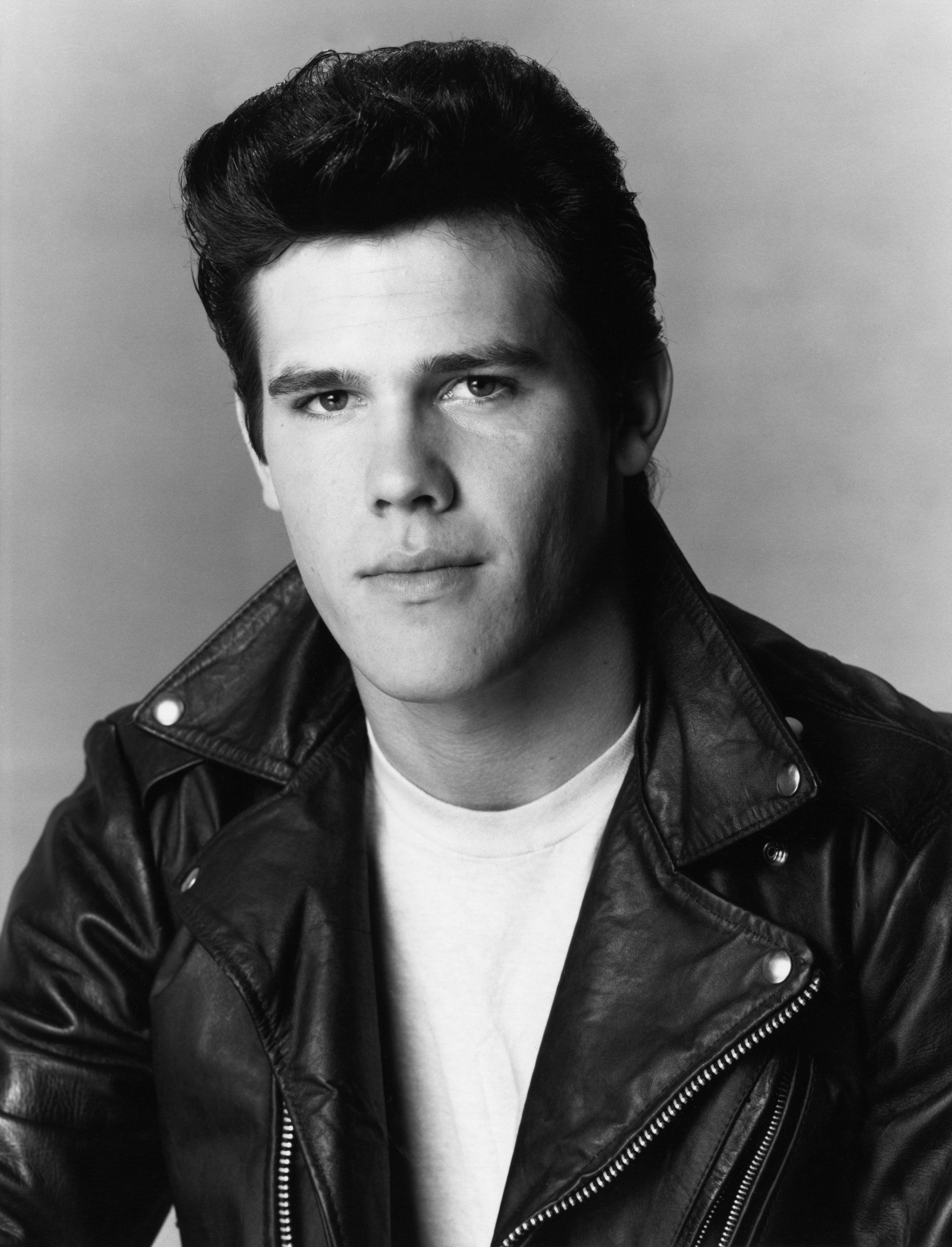 In this striking studio portrait, a 19-year-old Josh Brolin smolders as Johnny Betts in "Private Eye." With slicked-back hair, a leather jacket, and the brooding stare of a classic rebel, he looks every bit the all-American bad boy.