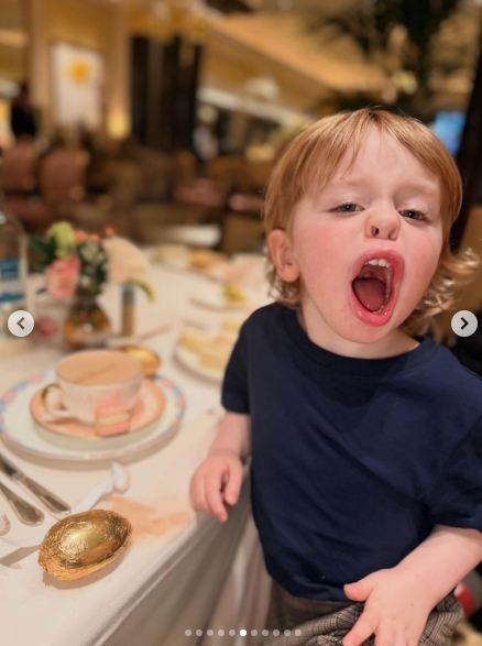 Sidney, three, looks absolutely beside himself with excitement at the afternoon tea table, his mouth wide open as a gleaming gold chocolate Easter egg sits waiting in front of him. A Dorchester-branded teacup and a plate of delicate sandwiches are visible just behind him, setting the scene for what appeared to be quite the holiday spread. | Source: Instagram/kellyosbourne