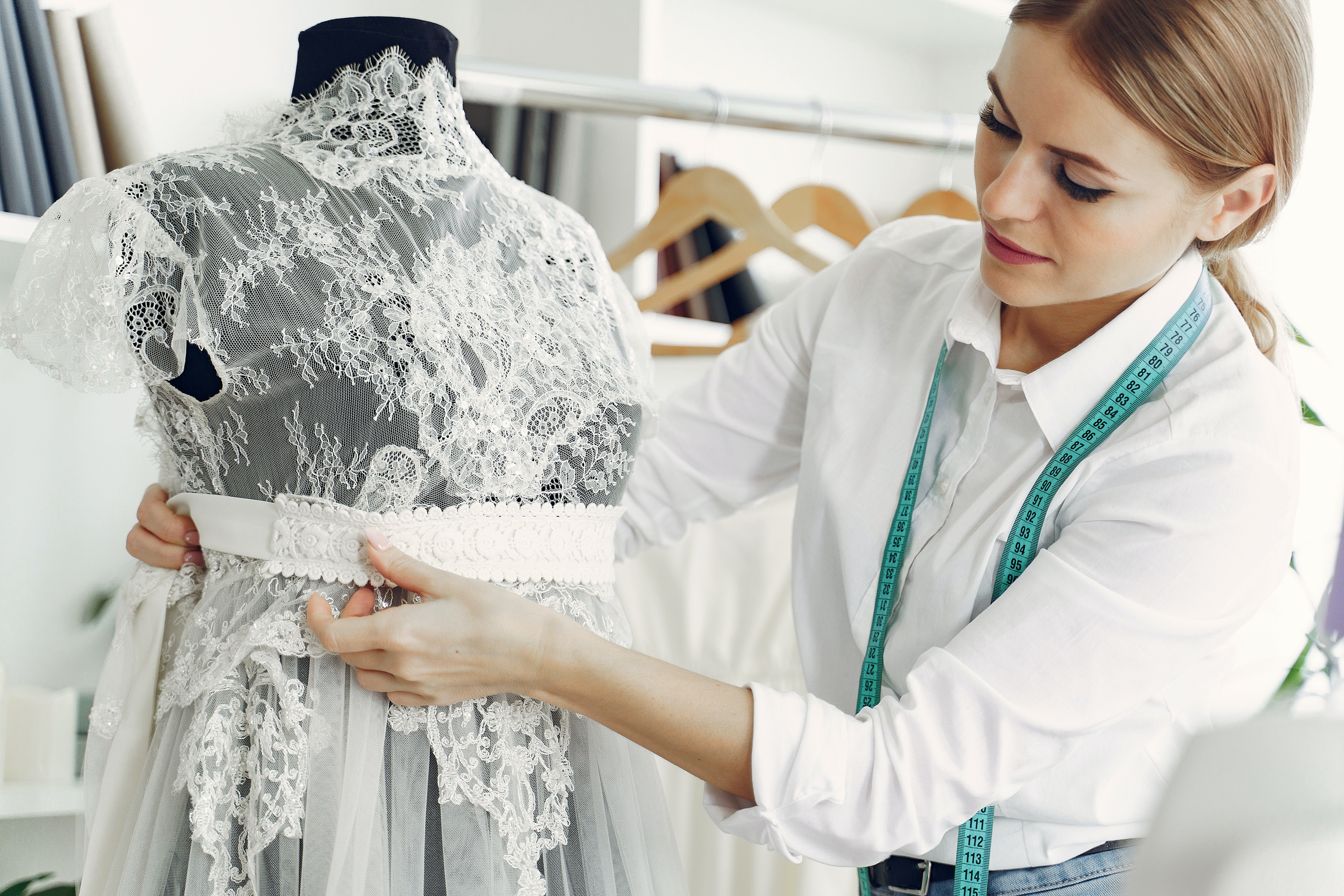 A wedding dress designer working on a dress | Source: Pexels
