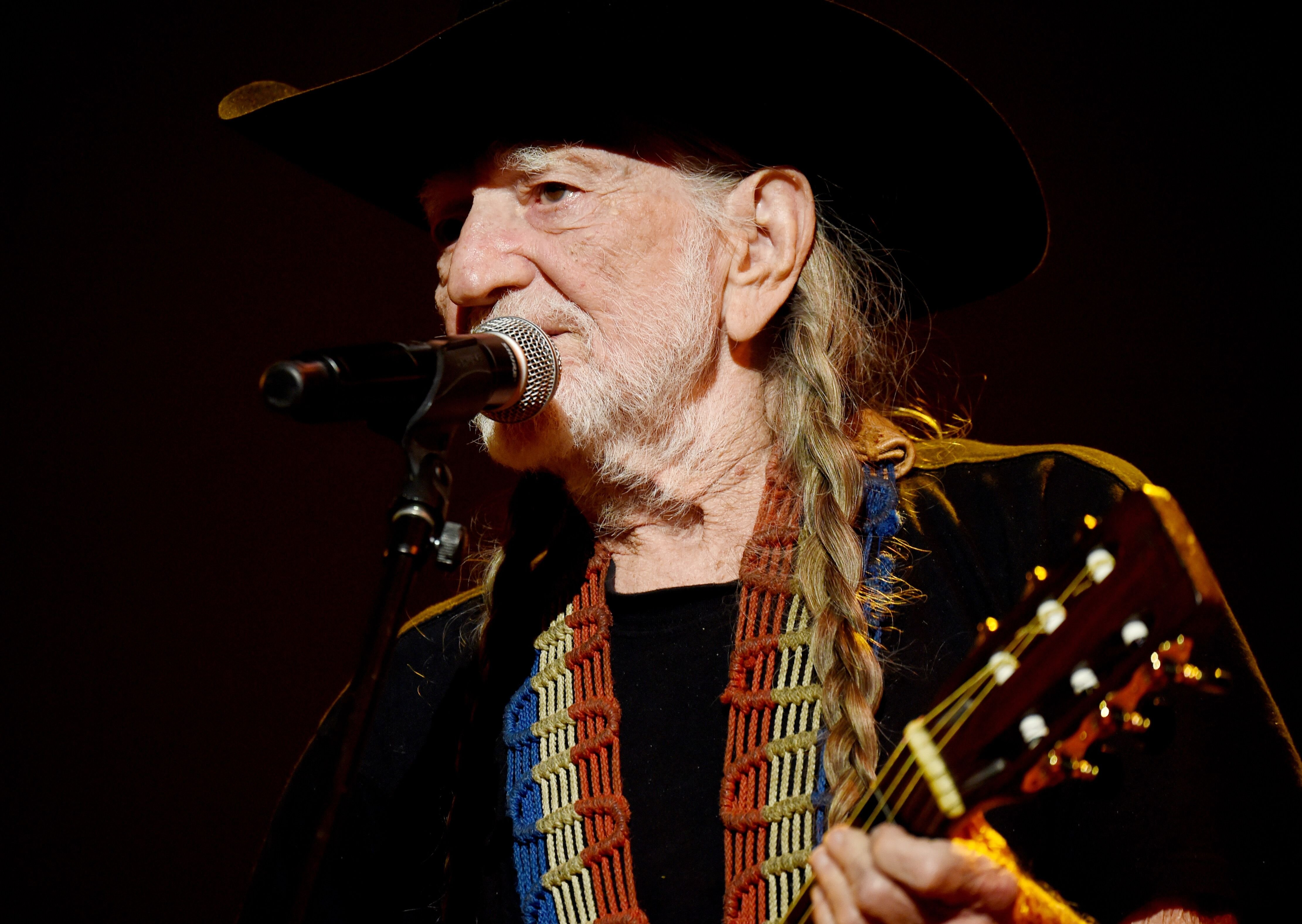 Willie Nelson performs onstage at the 25th anniversary MusiCares 2015 Person Of The Year Gala. | Source: Getty Images