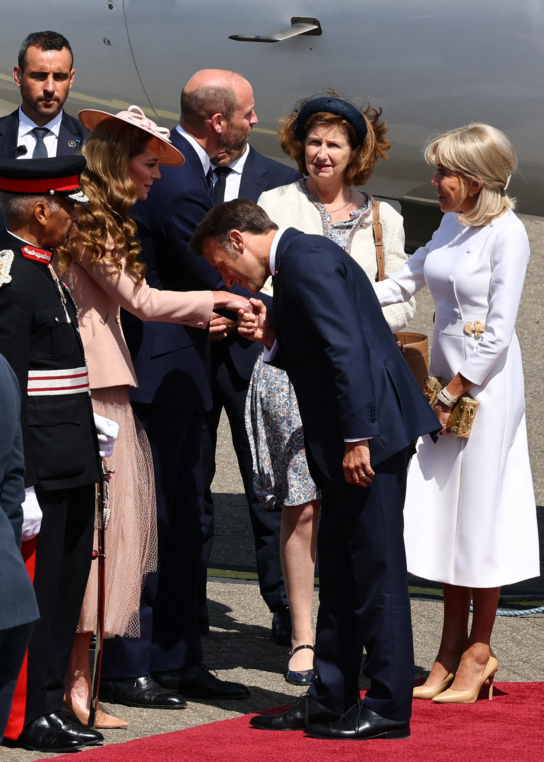 President Emmanuel Macron greeting Catherine, Princess of Wales, by kissing her hand at RAF Northolt on July 8, 2025. | Source: Getty Images