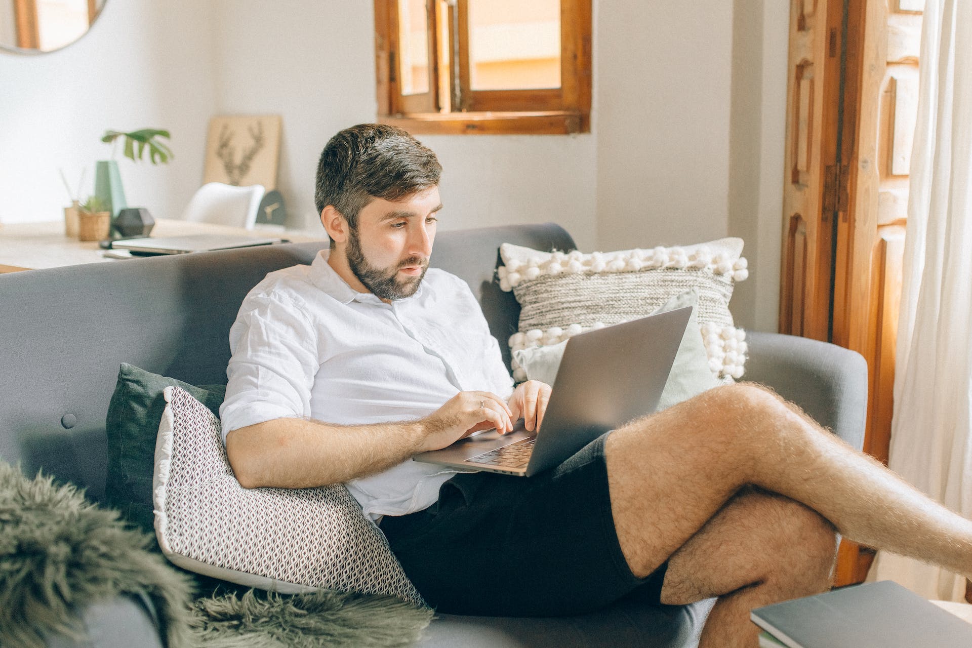 Man using laptop on couch | Source: Pexels