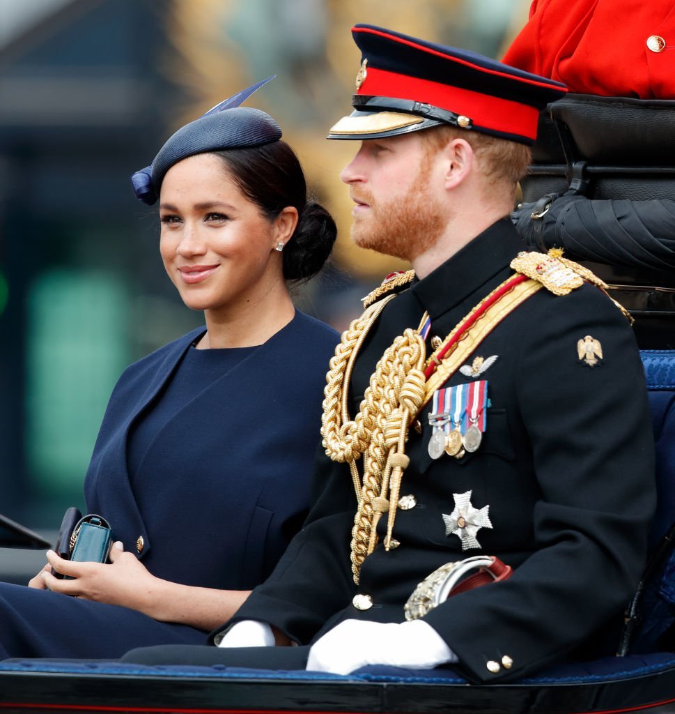 Meghan, Duchess of Sussex and Prince Harry, Duke of Sussex travel down The Mall in a horse drawn carriage during Trooping The Colour, the Queen's annual birthday parade | Photo: Getty Images