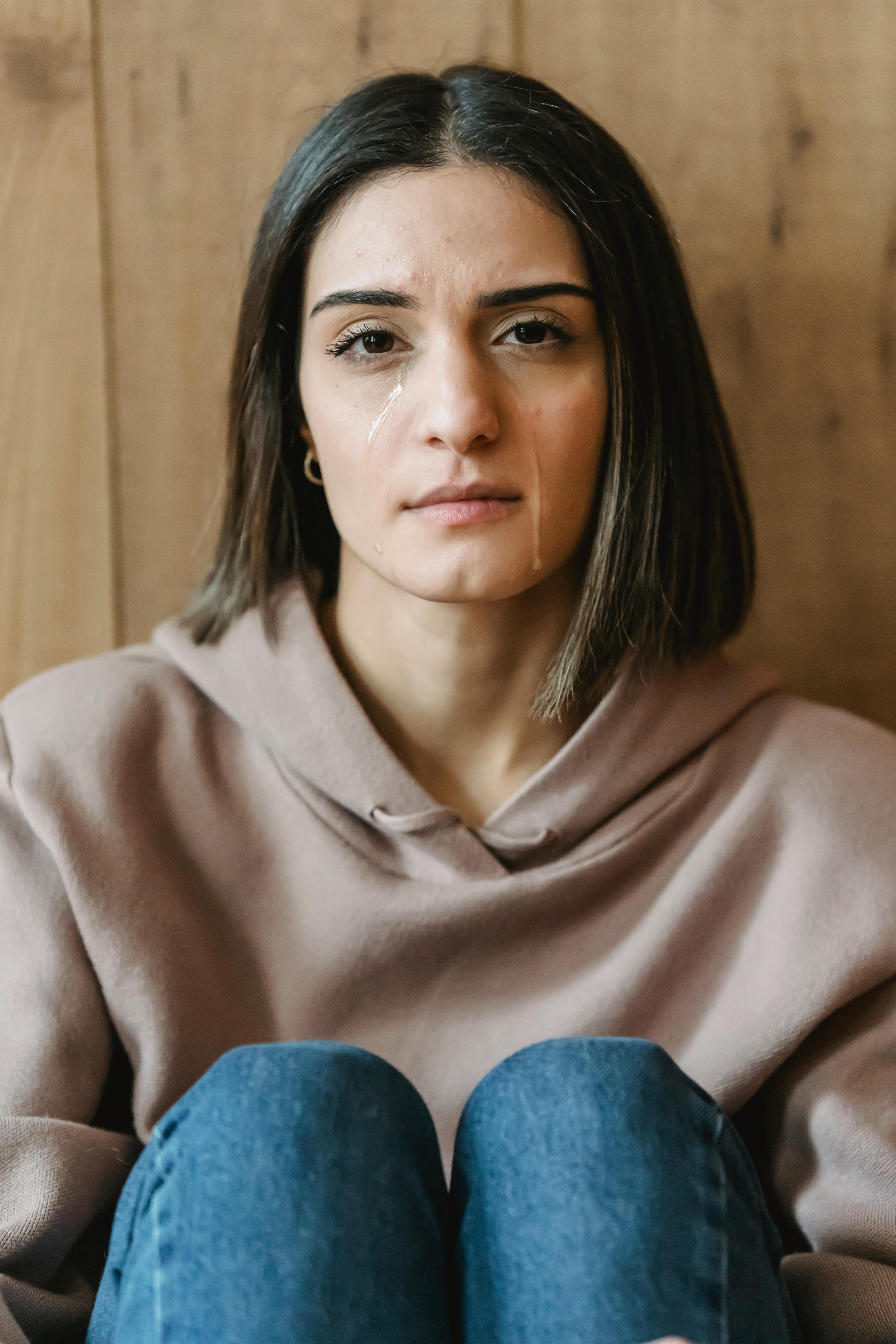 A young woman with tears running down her cheeks | Source: Pexels