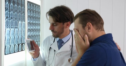 A young man receives bad news from his doctor. | Source: Shutterstock.