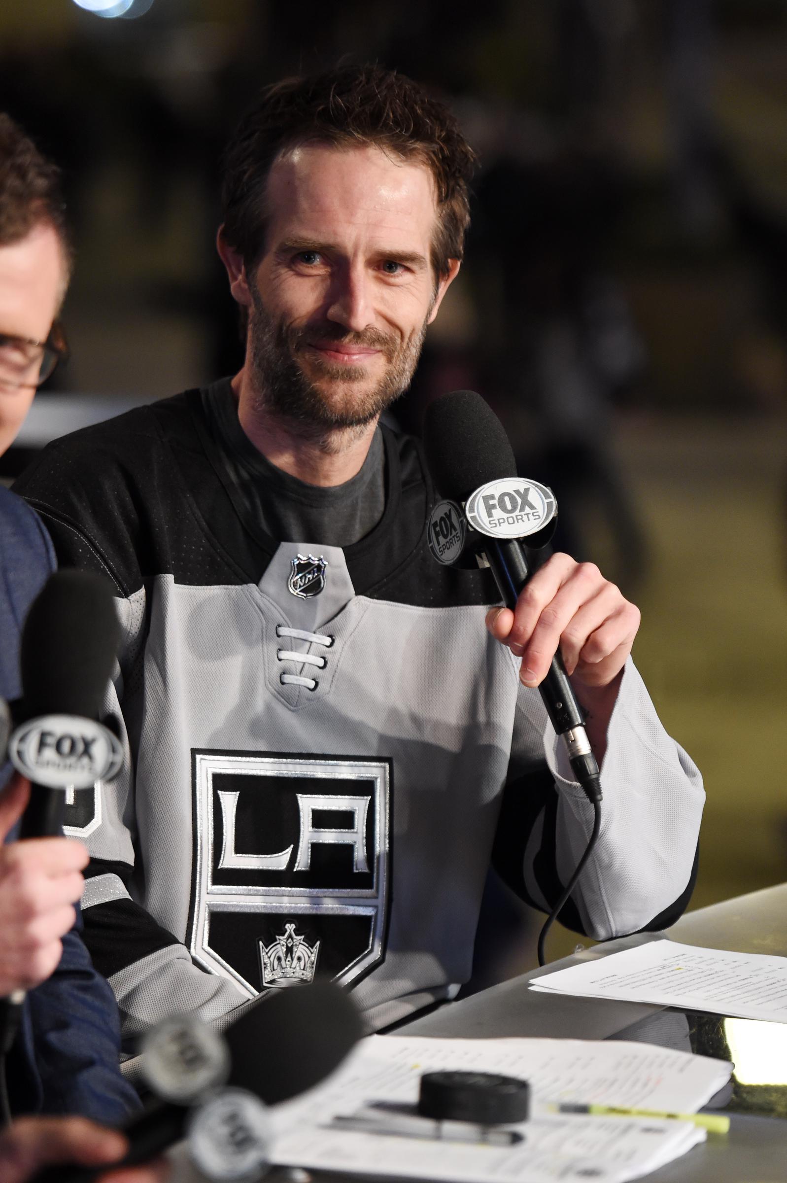 Sporting a Los Angeles Kings jersey, Michael Vartan smiles while serving as Celebrity Guest of Honor at an NHL game. The actor looked at ease blending into the world of sports.