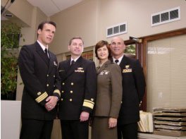 RADM Don Guter with "Commander Harmon "Harm" Rabb, Jr. (David James Elliott), Lt. Colonel Sarah "Mac" MacKenzie (Catherine Bell),  and “JAG” Admiral Chegwidden (John M. Jackson). | Source: Wikimedia Commons.