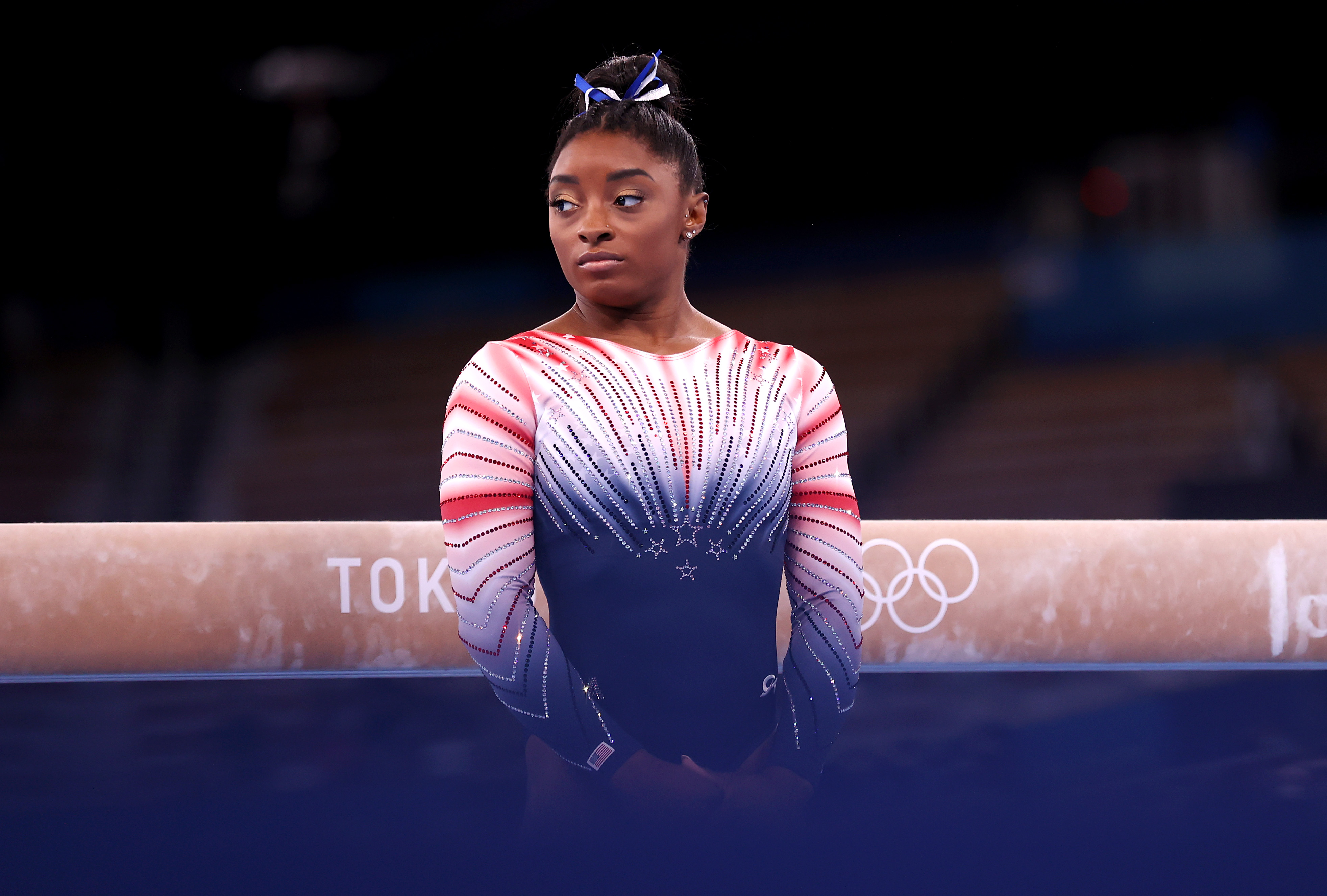Biles stands poised before competing in the women's balance beam final at the Tokyo 2020 Olympic Games on August 3, 2021, at Ariake Gymnastics Centre. Under the global spotlight and immense pressure, the champion gymnast delivered a performance that captivated the world.