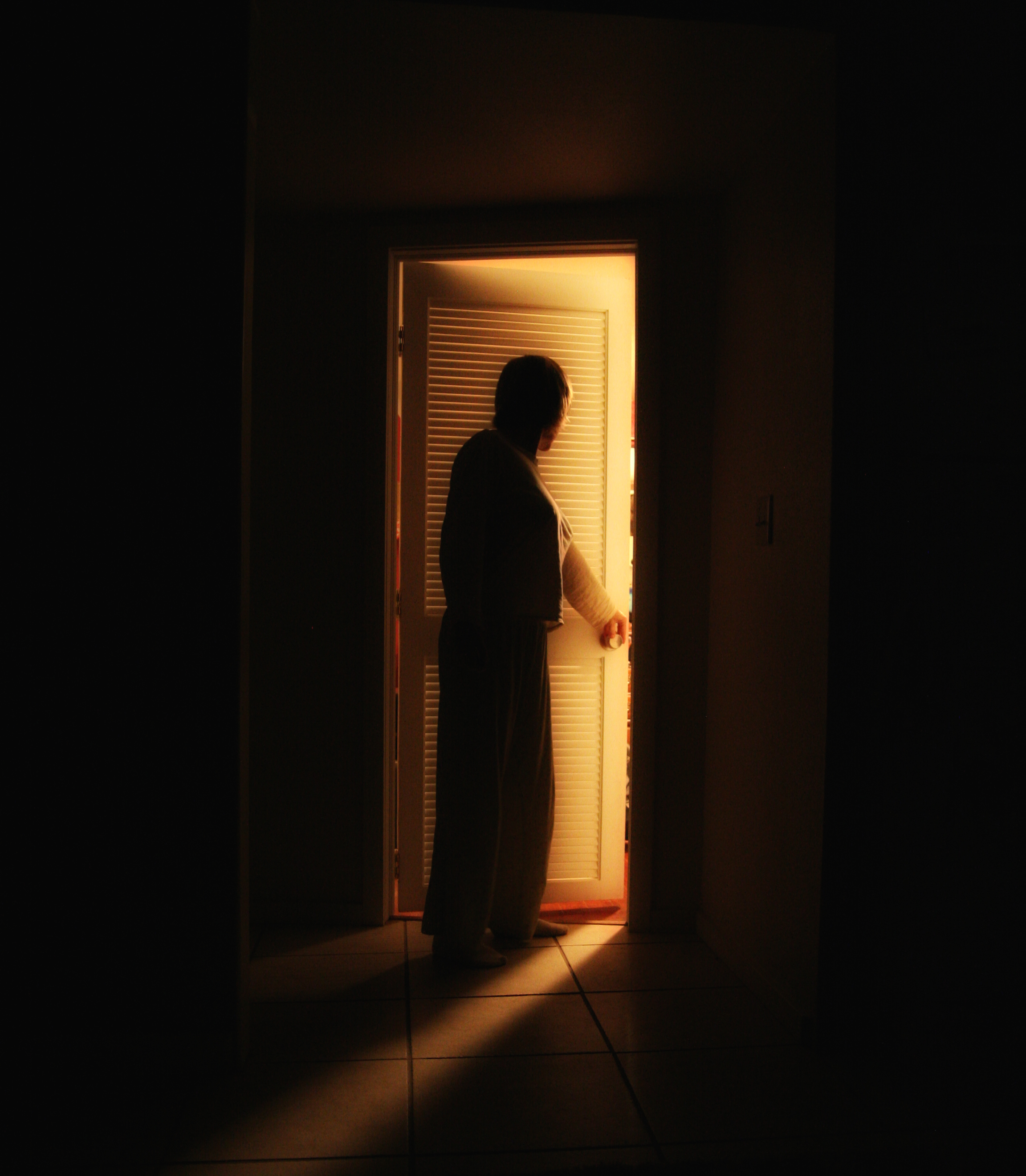 A person outside a bedroom door | Source: Shutterstock.com