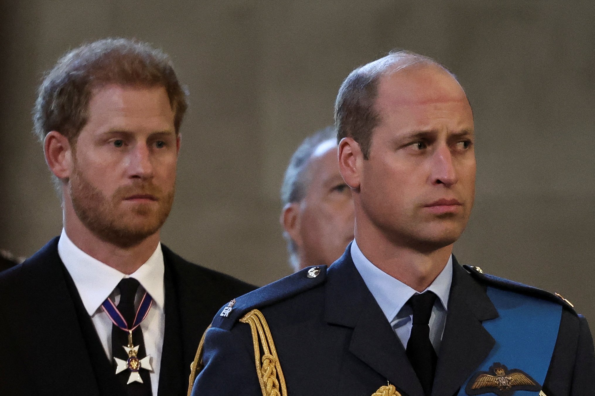 Prince Harry and Prince William reacts as the coffin of Britain's Queen Elizabeth II arrives at the Palace of Westminster, following a procession from Buckingham Palace, in London on September 14, 2022. | Source: Getty Images