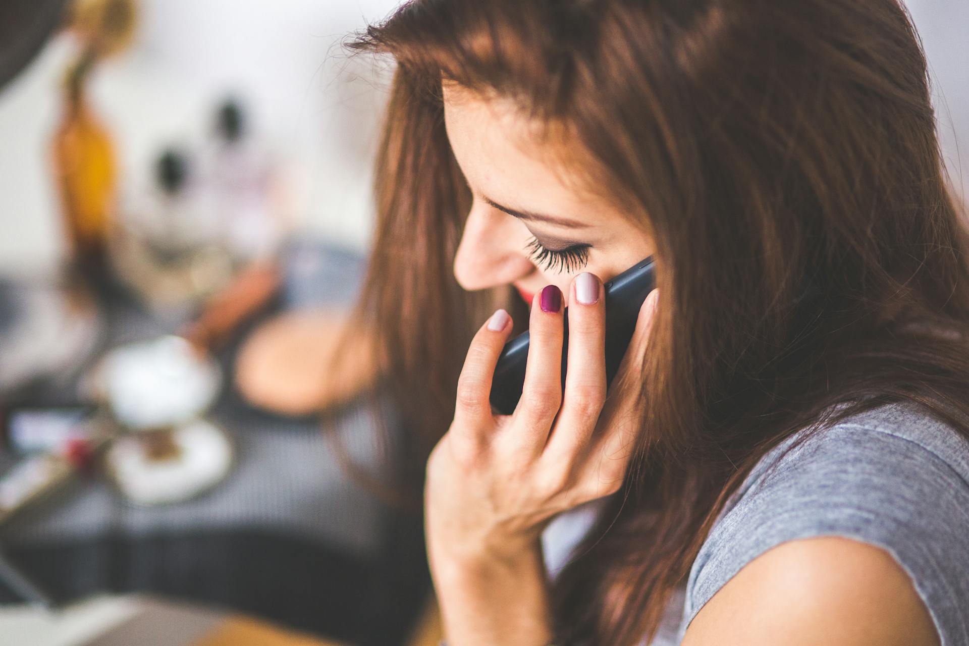 A relieved woman talking over the phone | Source: Pexels