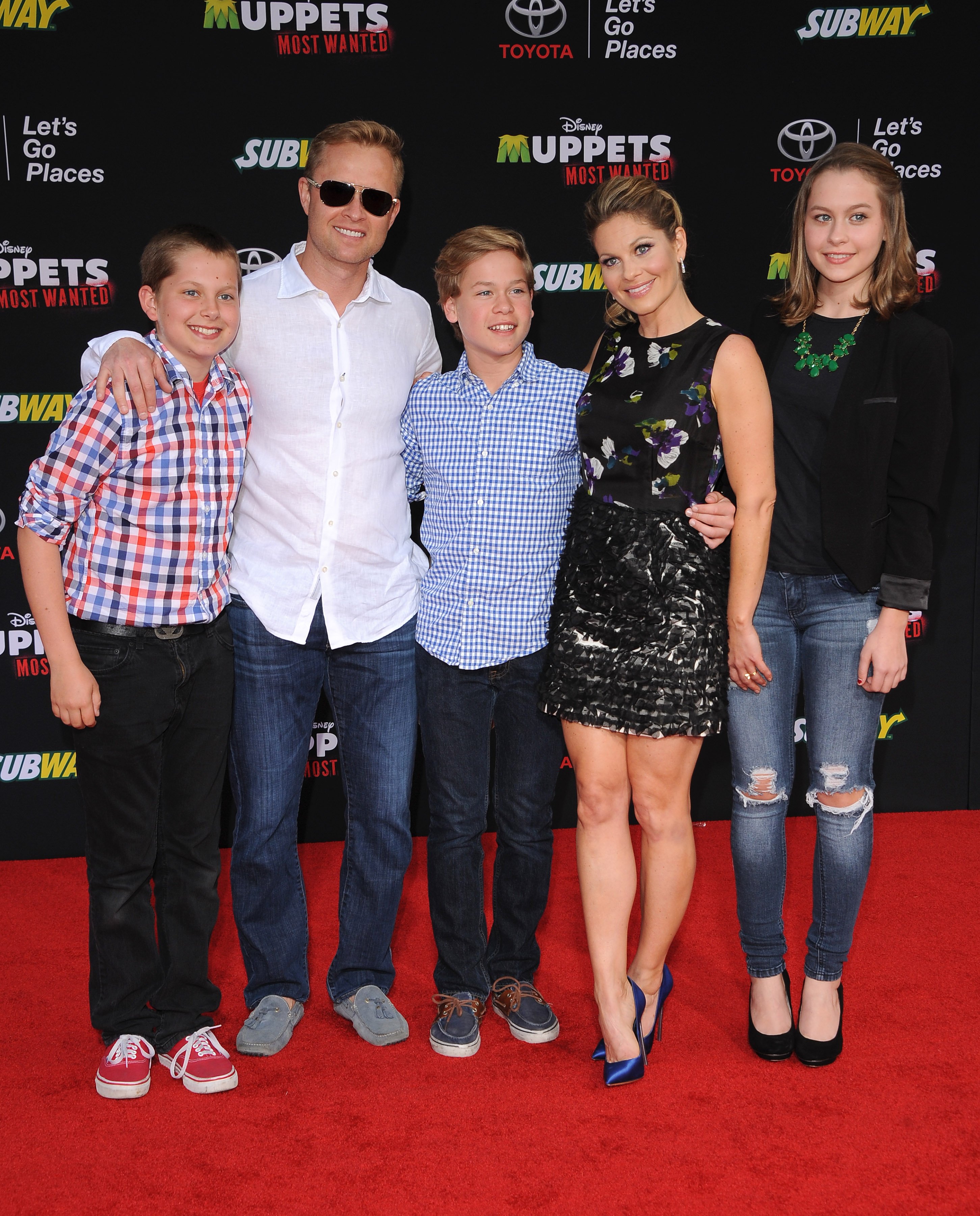 Actress Candace Cameron-Bure, husband Valeri Bure, daughter Natasha Bure, sons Lev Bure and Maksim Bure arrive at the Los Angeles premiere of 'Muppets Most Wanted' at the El Capitan Theatre on March 11, 2014 in Hollywood, California. | Source: Getty Images