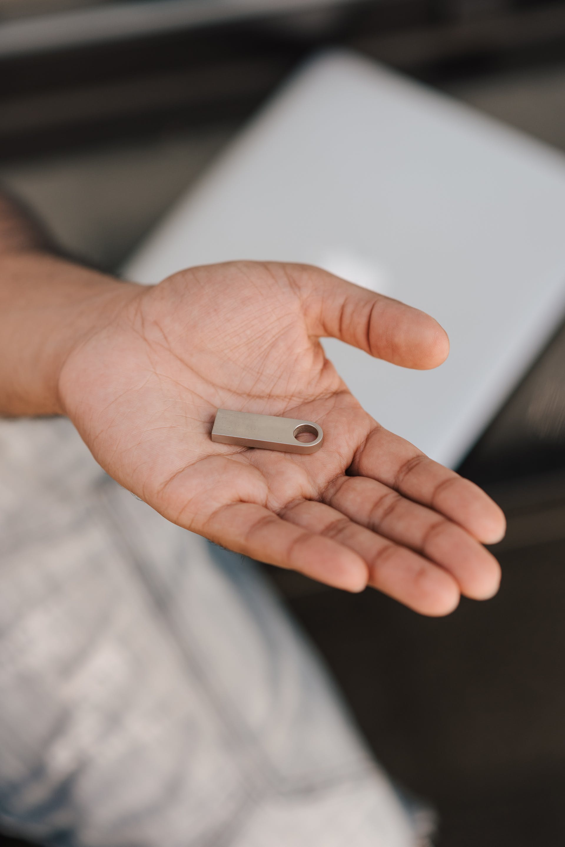 A person holding a USB drive | Source: Pexels