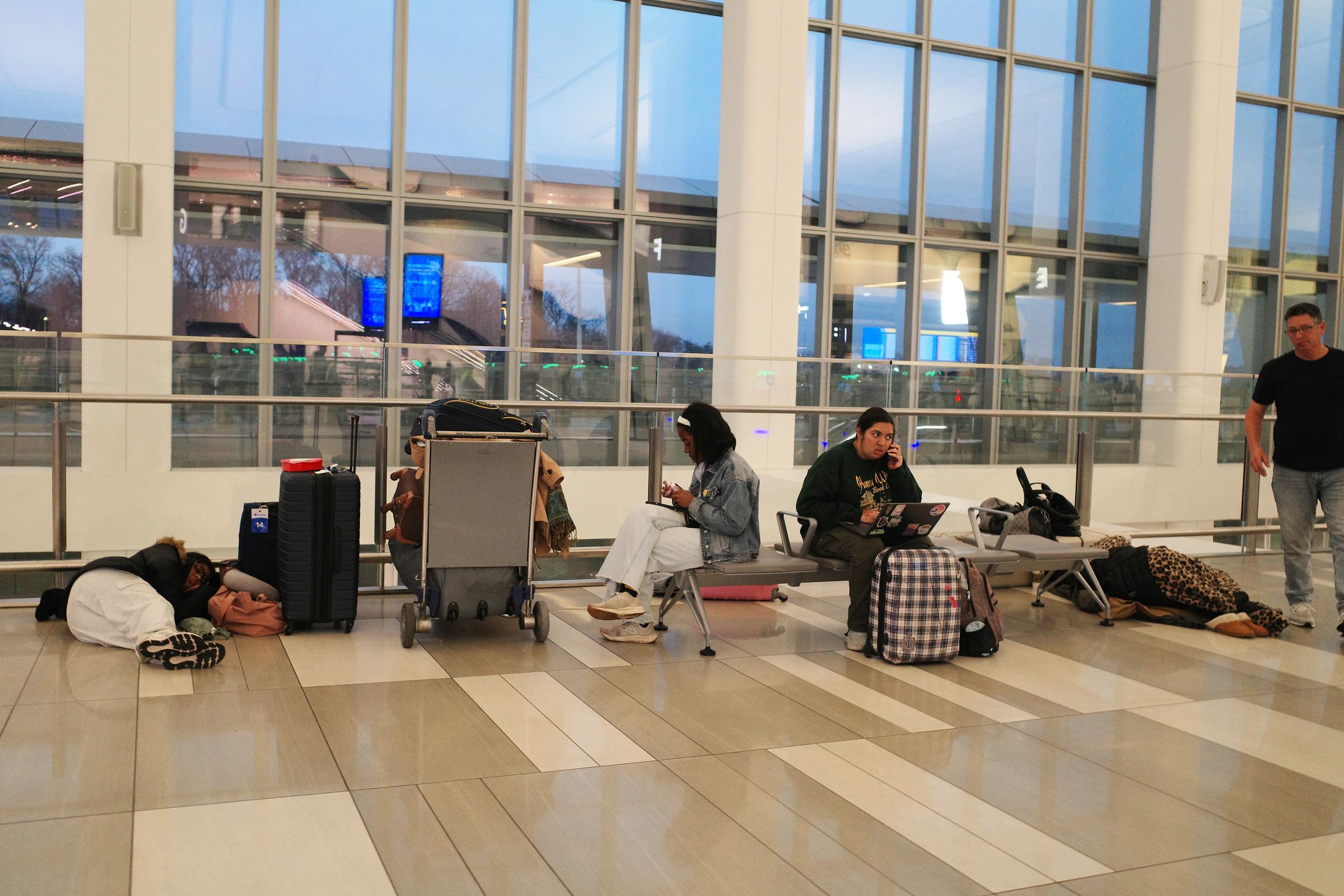 Passengers stay around after flights were cancelled at Terminal B in LaGuardia Airport on March 23 | Source: Getty Images