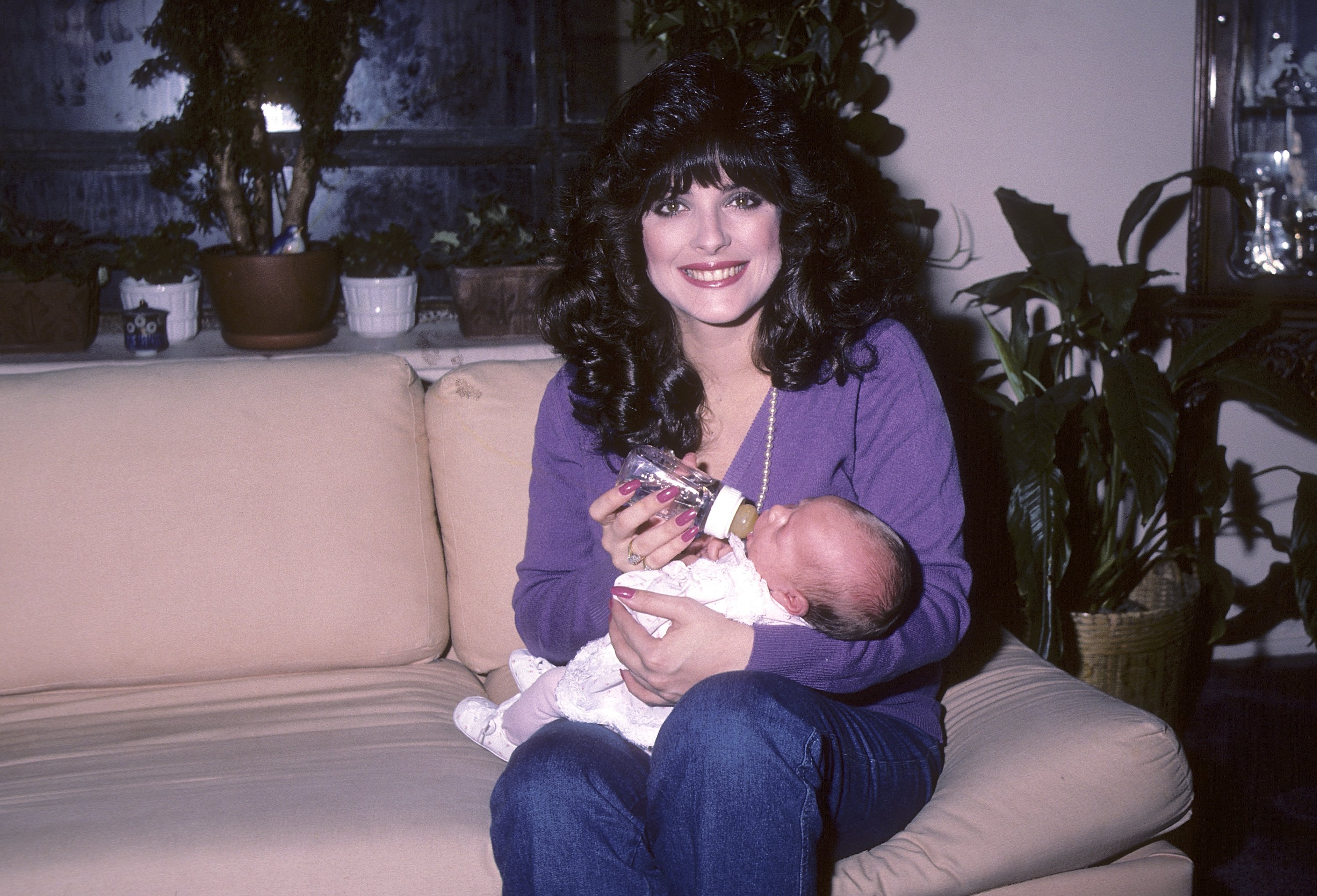Lisa Loring holds her newly born daughter, Marianne Stevenson, on January 31, 1984, at her apartment in New York City. | Source: Getty Images