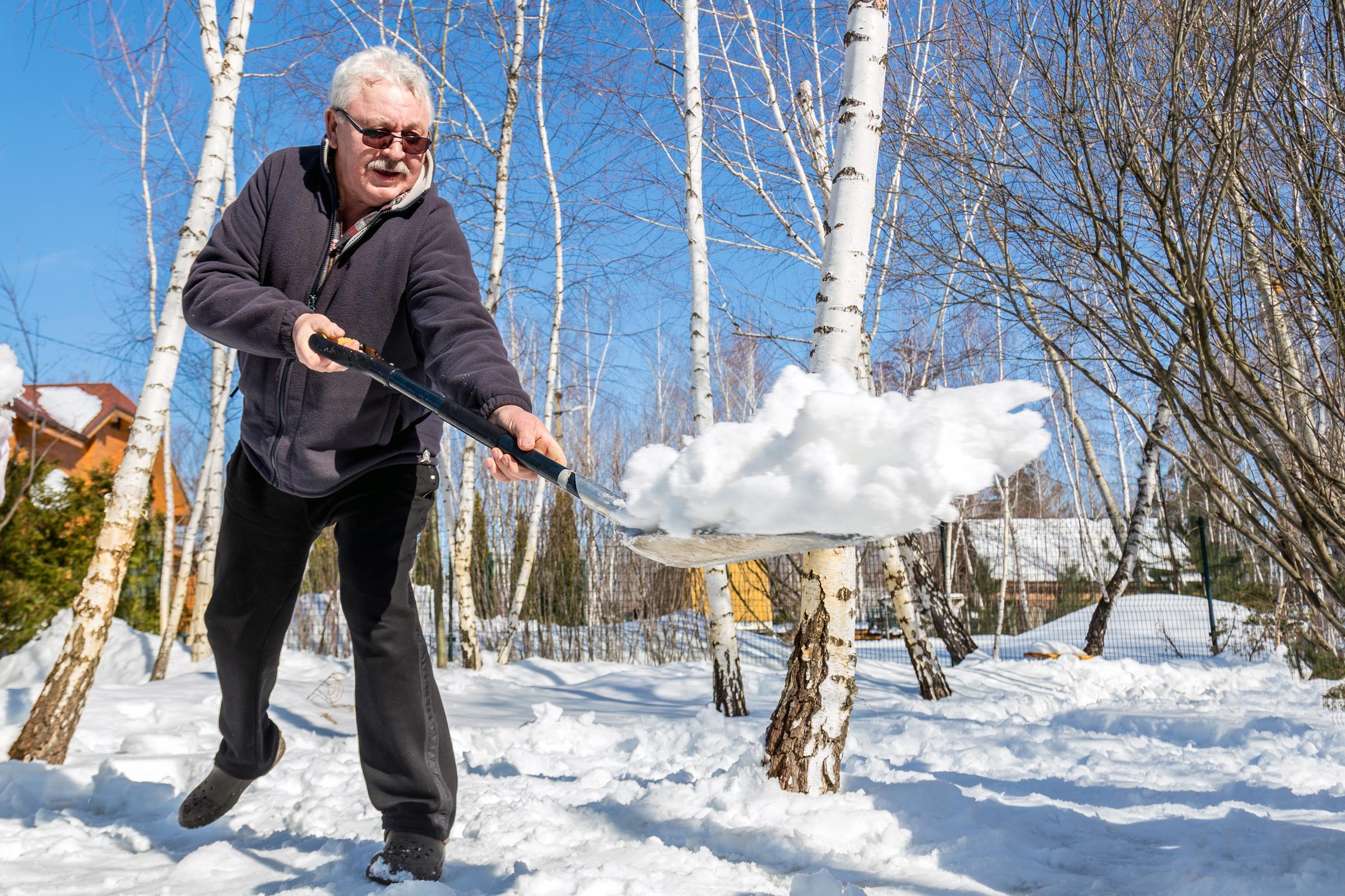 Senior man throwing snow with a shovel | Source: Shutterstock