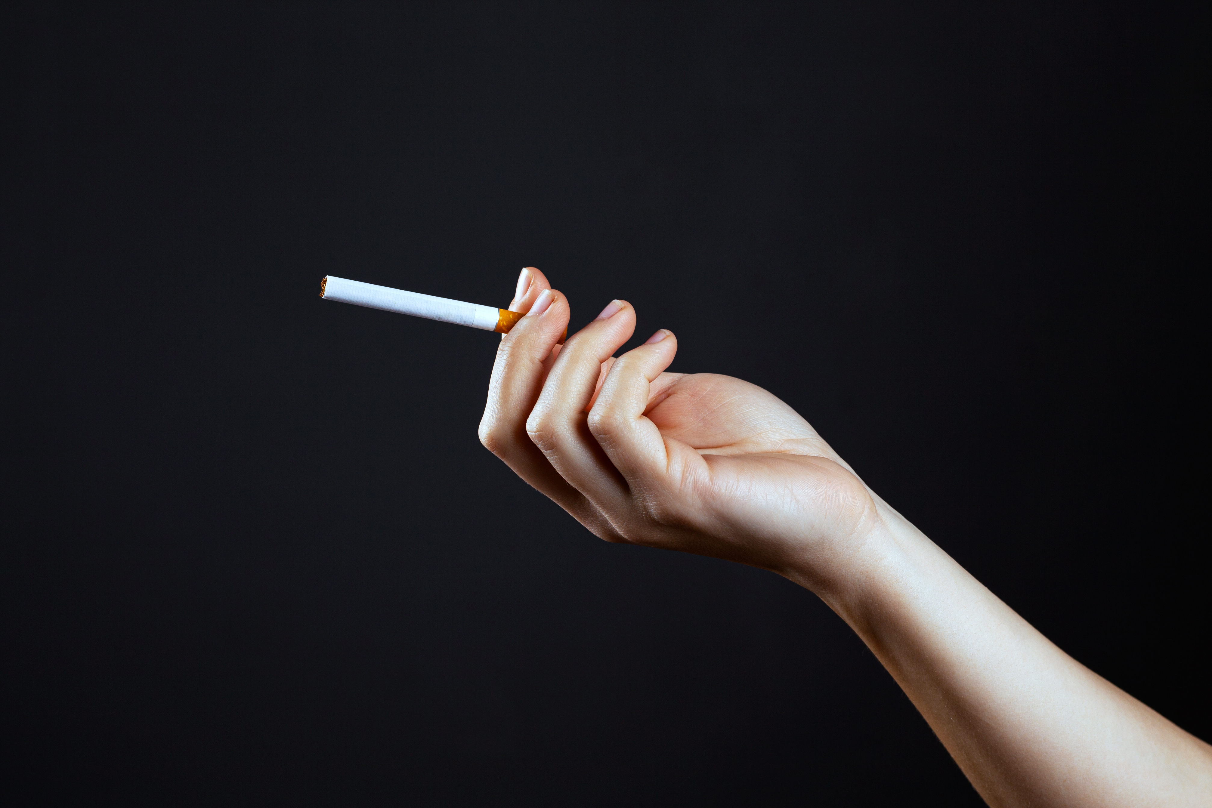 Female hand holding a cigarette | Source: Shutterstock