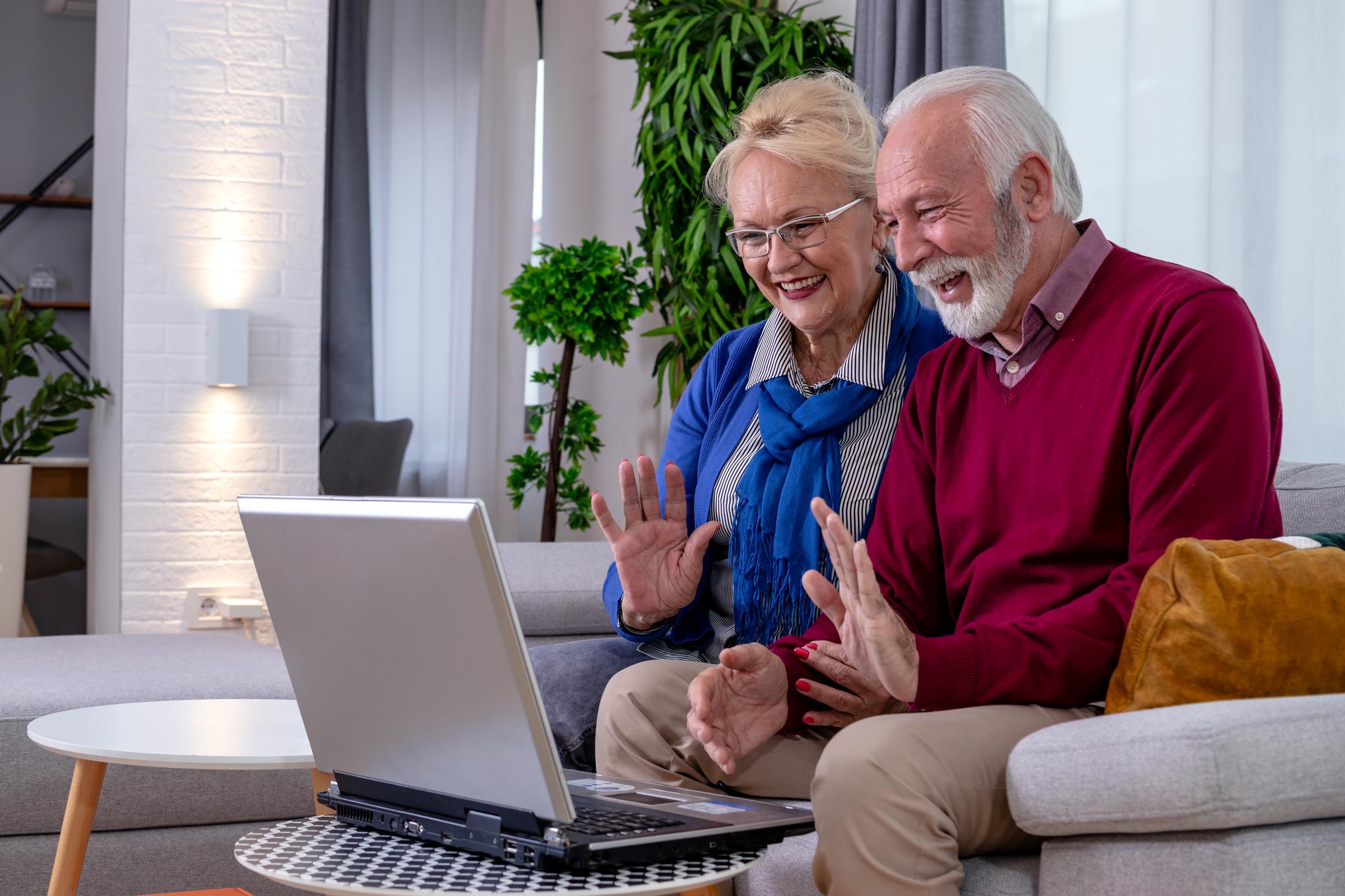 Elderly couple communicating with family through a video call | Source: Shutterstock