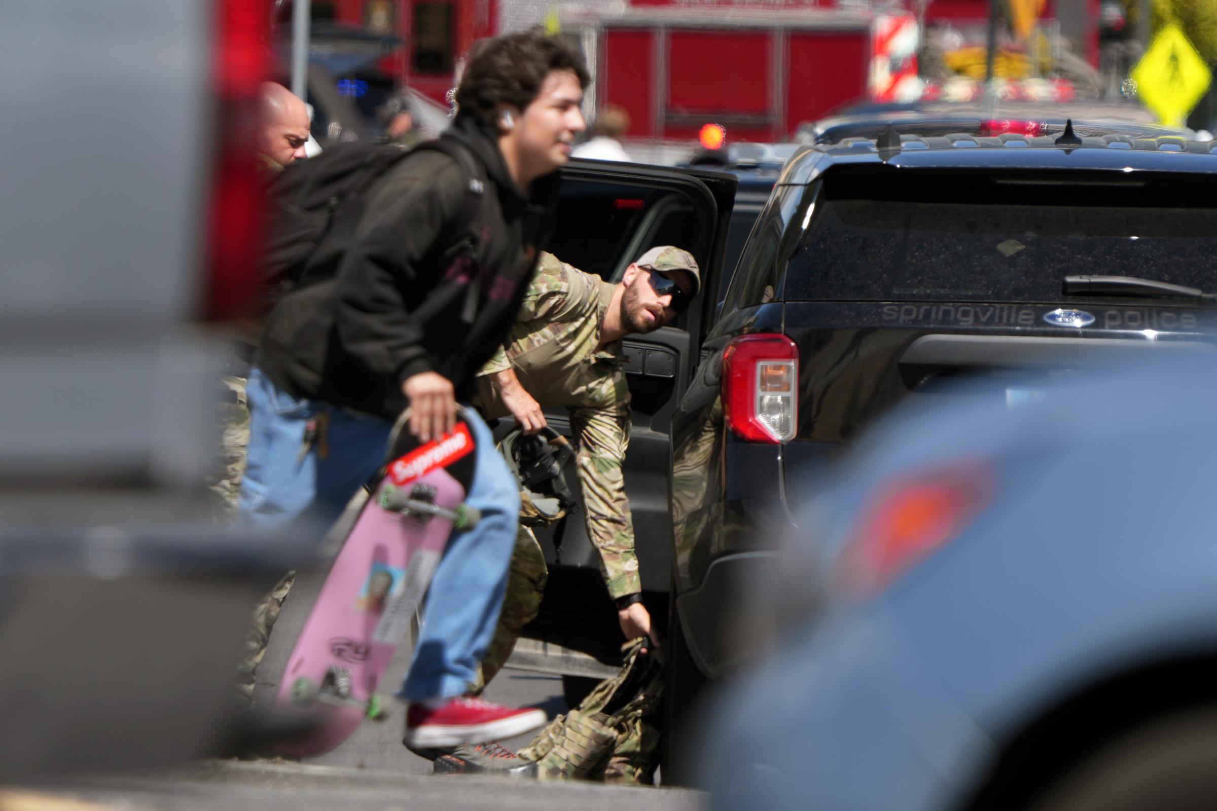 A man with a skateboard evacuates as law enforcement responds to the scene of the shooting at Utah Valley University, on September 10, 2025 | Source: Getty Images
