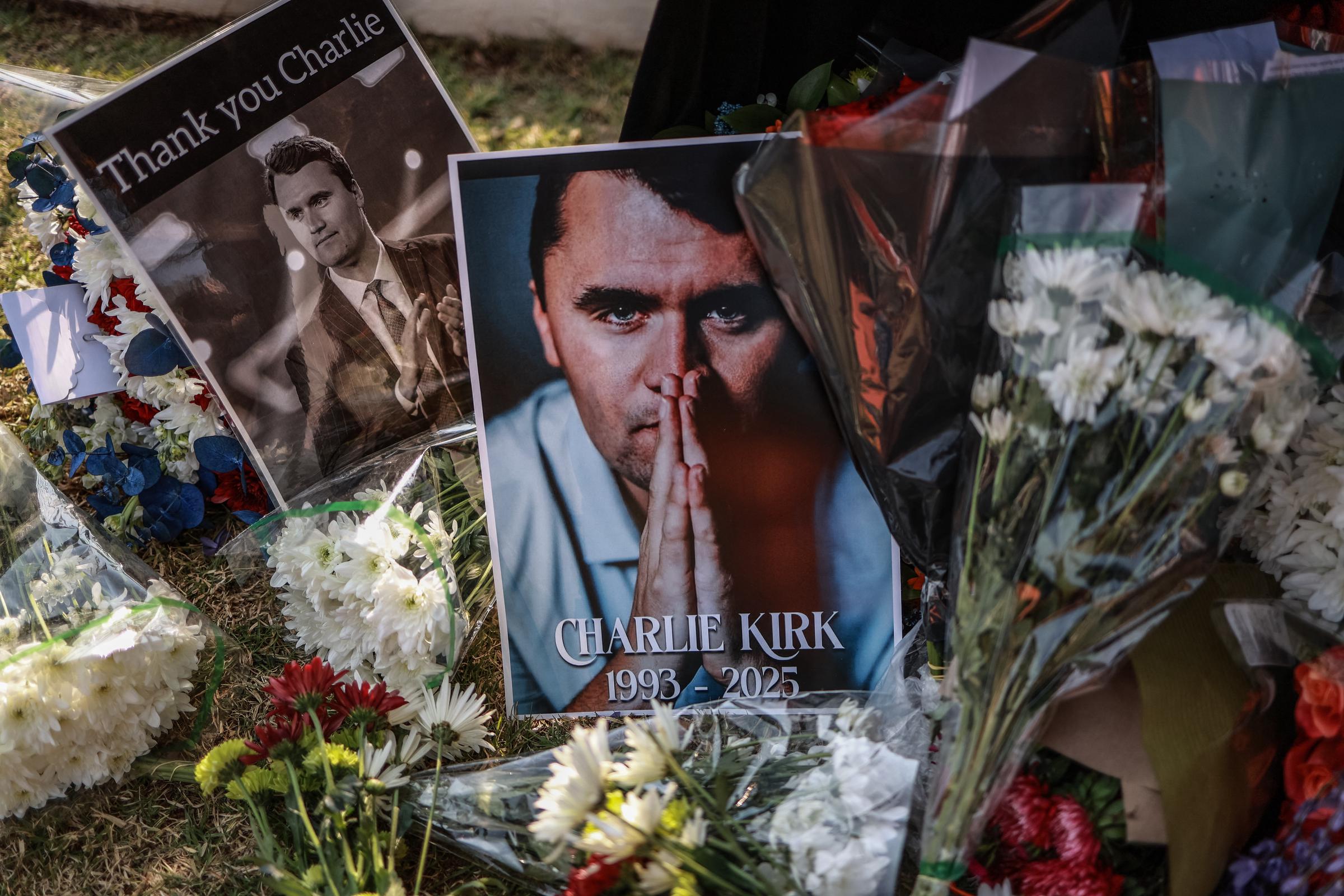 Flowers and tribute photos honoring Charlie Kirk are placed outside the U.S. Embassy in Pretoria, South Africa, on September 11, 2025, following news of his death