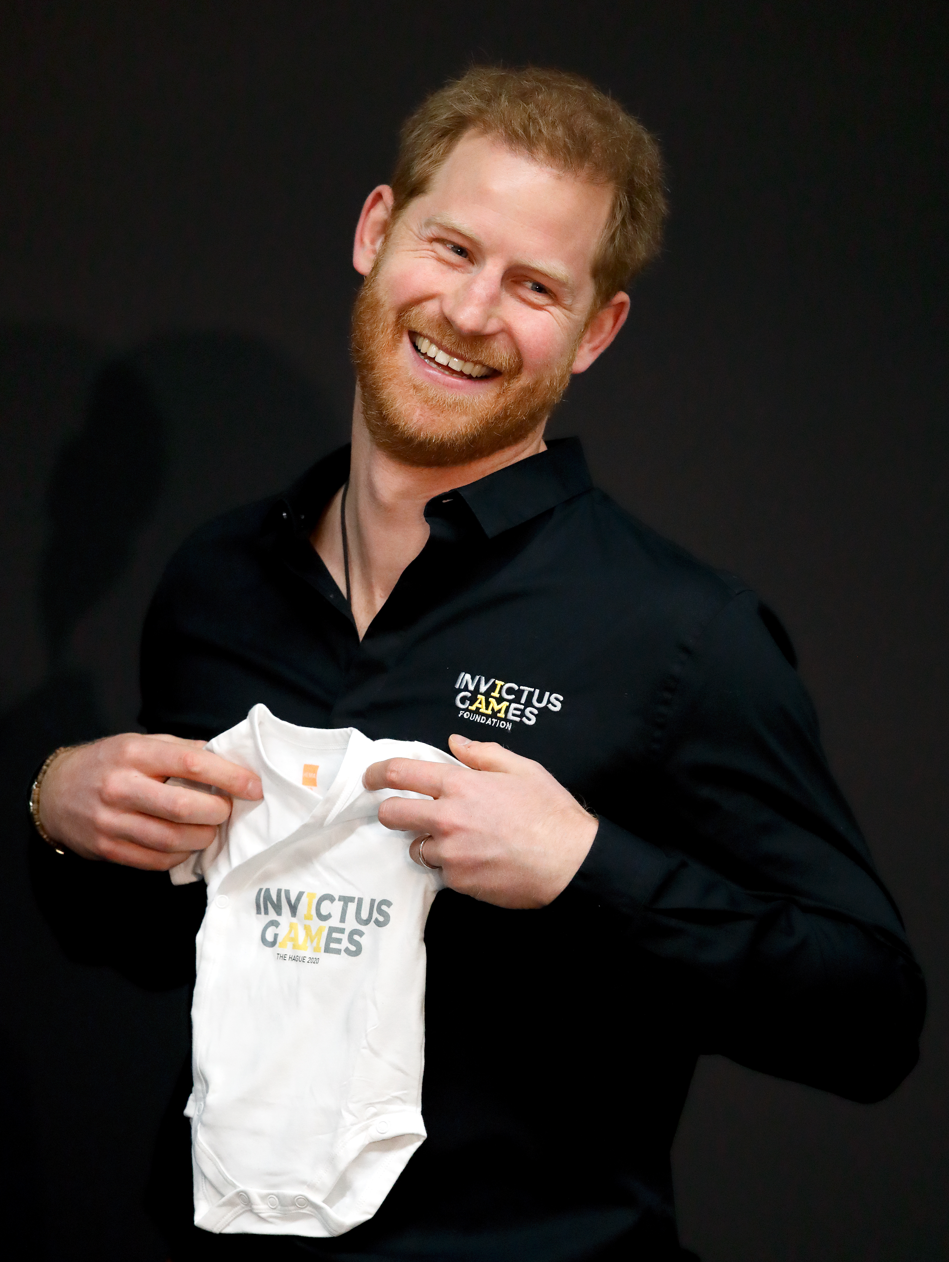Prince Harry, Duke of Sussex is presented with an Invictus Games baby grow for Archie as he officially launches the Invictus Games in The Hague, Netherlands, on May 9, 2019. | Source: Getty Images