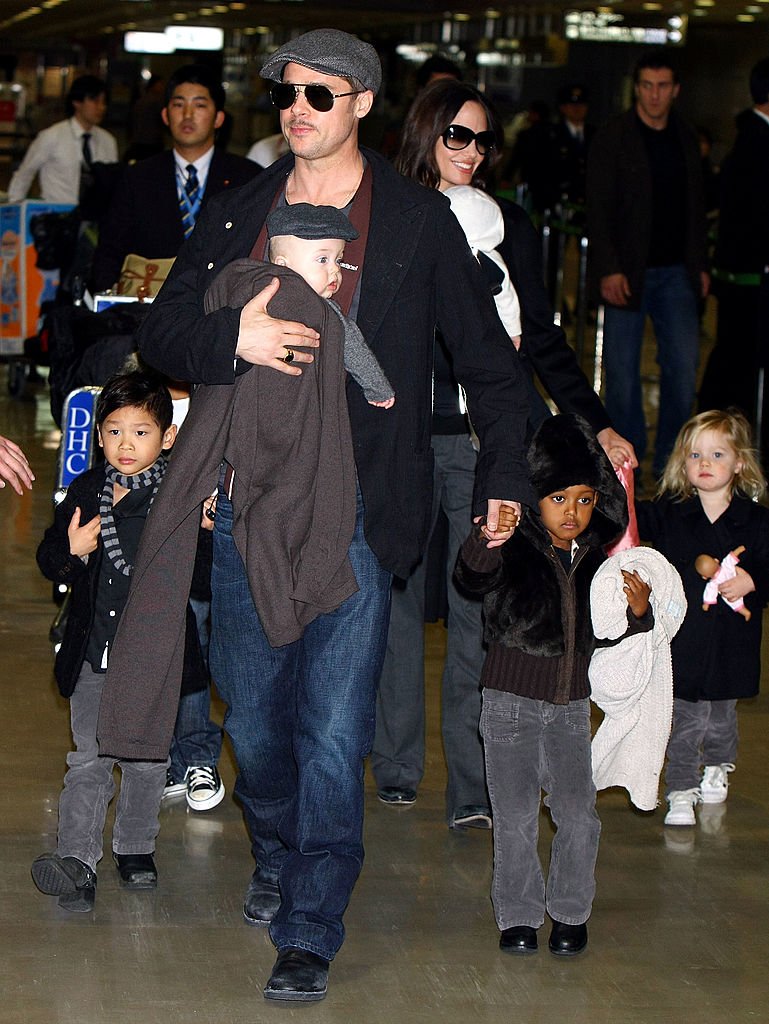 Pitt sosteniendo a Knox en una mochila porta bebé mientras caminaba con sus otros hijos. | Foto: Getty Images