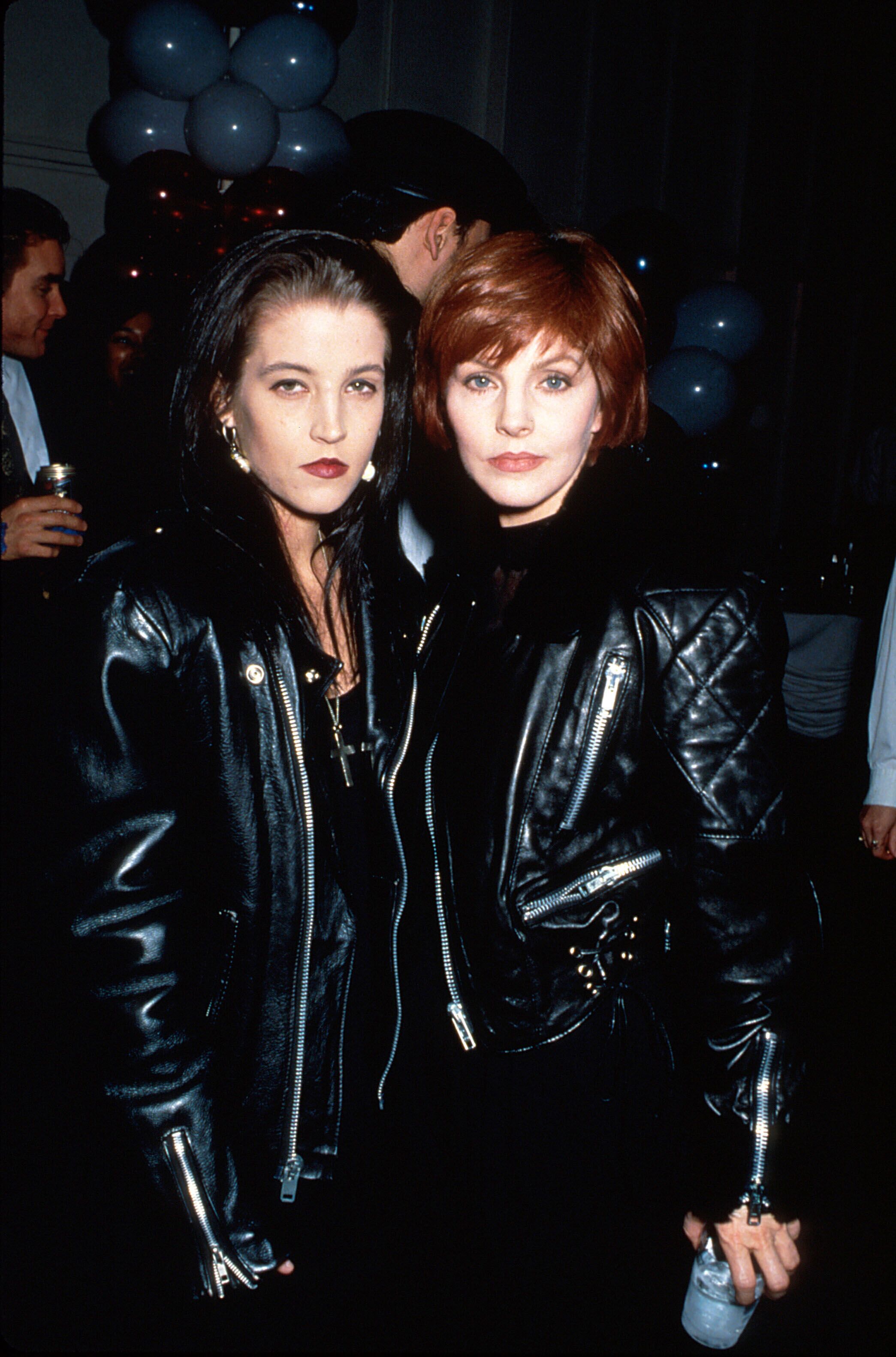 Lisa Marie Presley and mother, actress Priscilla Presley, both wearing Elvis-style black leather jackets | Source: Getty Images