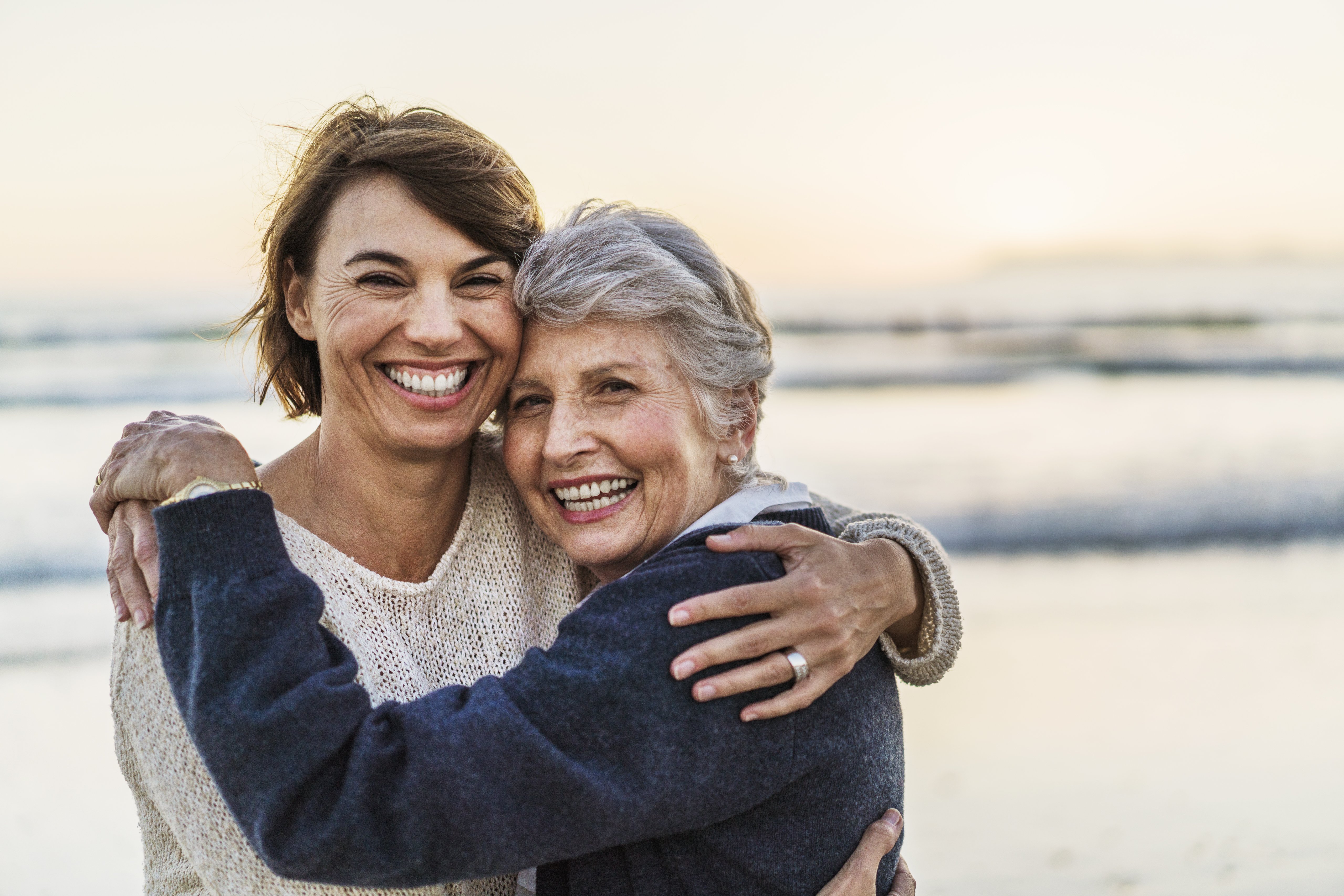 A photo of happy mother embracing female. Portrait of daughter with senior woman. They are at beach.|Photo: Getty Images