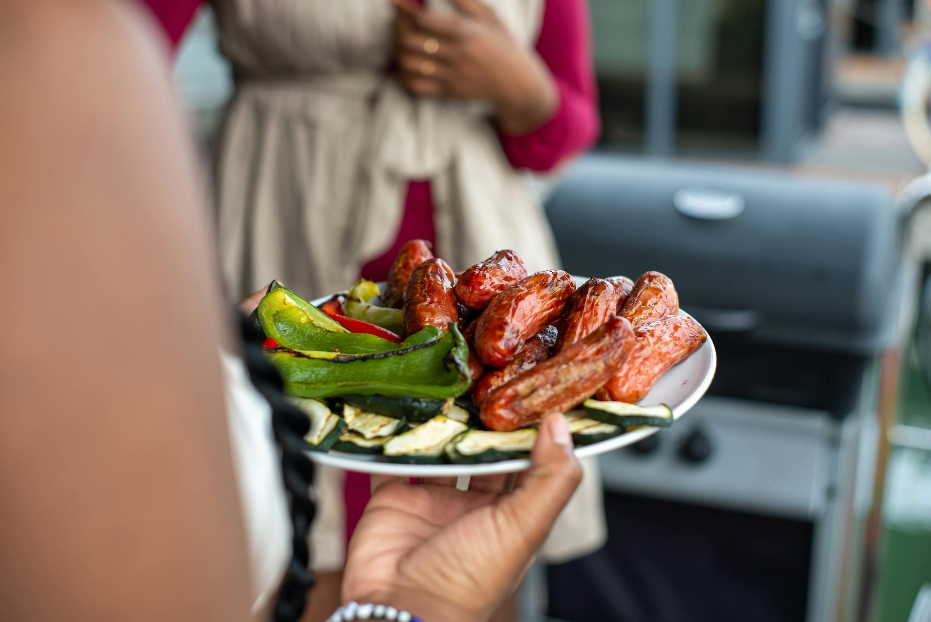 A woman holding food on a plate | Source: Pexels