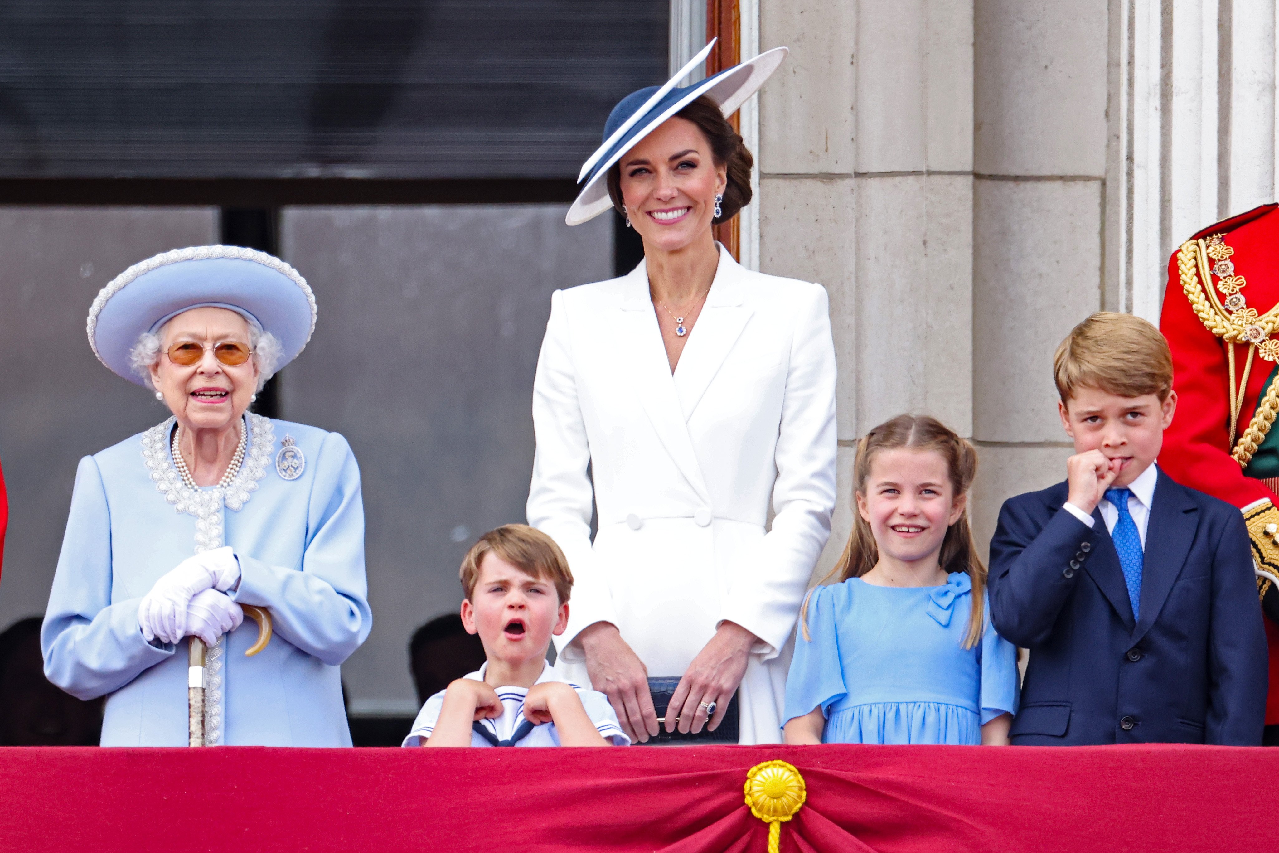 Queen Elizabeth II, Prince Louis, Catherine, and Princess Charlotte watch the RAF flypast from the balcony of Buckingham Palace during the Trooping the Color parade on June 02, 2022, in London, England. | Source: Getty Images