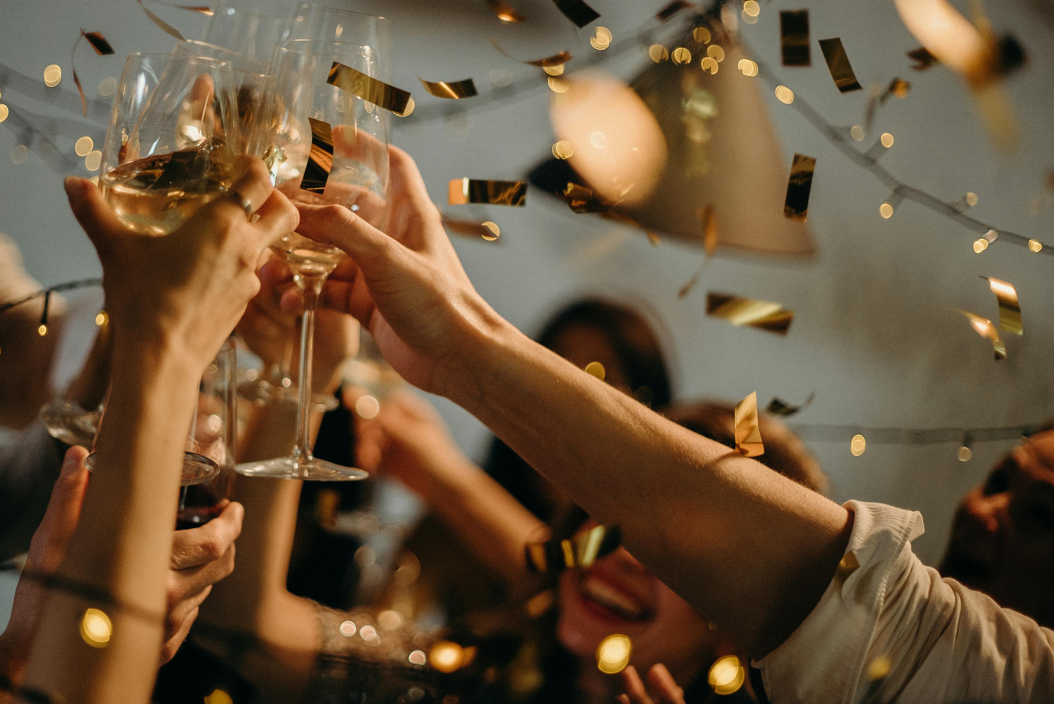 People clinking their glasses together at a party | Source: Pexels