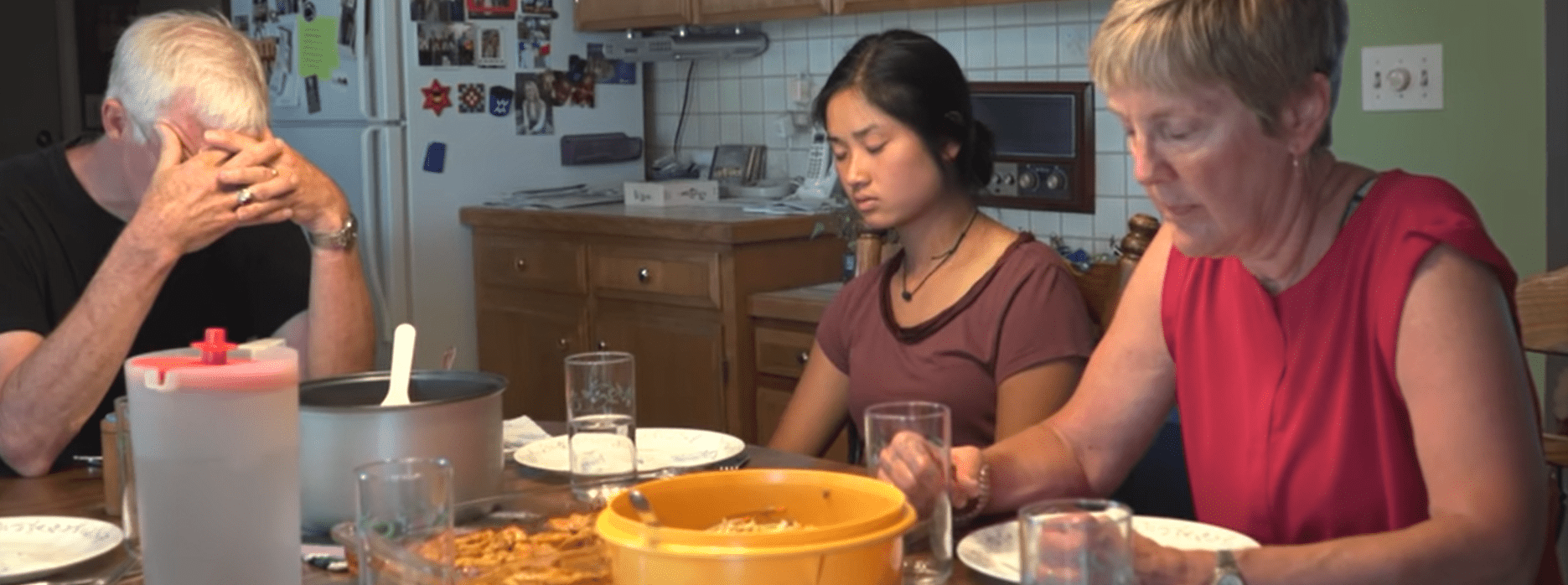 Kati Pohler at the dining table with her adoptive parents, Ken and Ruth Pohler  | Source: YouTube/BBC Stories