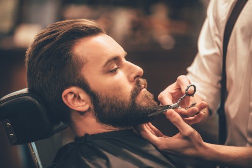 A young man having his beard trimmed. | Source: Shutterstock. A young man having his beard trimmed. | Source: Shutterstock.