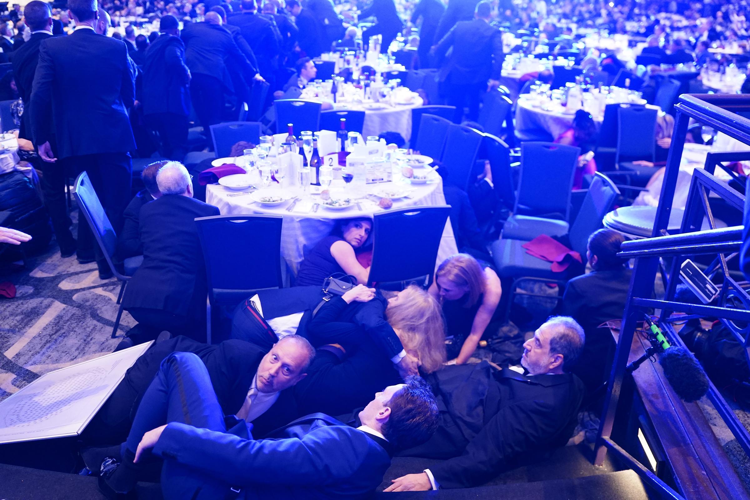 Richard Strauss, Jamie Raskin, Kerry Kennedy, Jackie Kucinich and Paul Strauss hide under tables after an incident at the White House Correspondents Association dinner at the Washington Hilton on April 25, 2026, in Washington, DC | Source: Getty Images