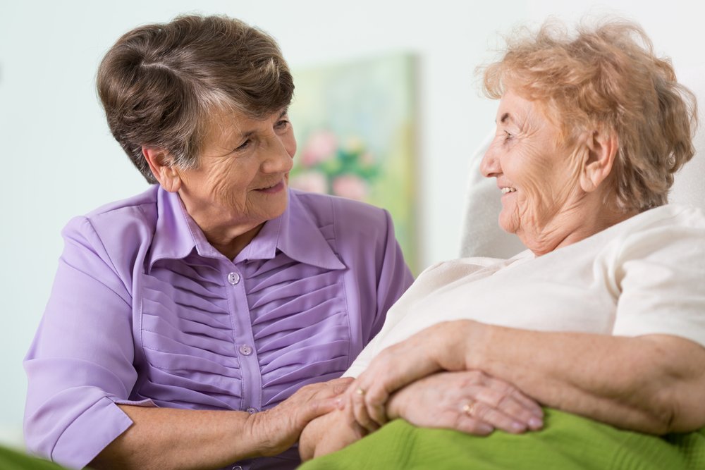 Happy elder woman spending time with her ill friend | Source: Shutterstock