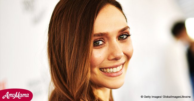 Elizabeth Olsen, 29, puts her cleavage on display while sporting a plunging green mini-dress