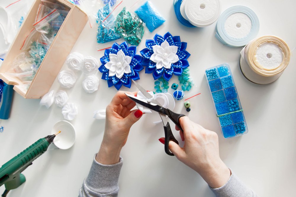 Woman engaged in creative work with art supplies | Photo: Shutterstock/Kostikova Natalia