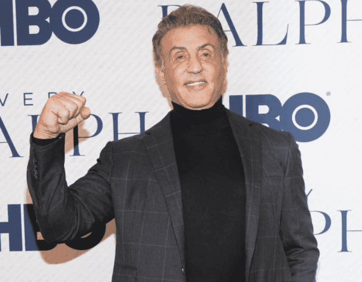 Sylvester Stallone poses with his fist in the air at the premiere of the HBO Documentary Film "Very Ralph," on November 11, 2019, in Beverly Hills, California | Source: Getty Images (Photo by Rachel Luna/WireImage)