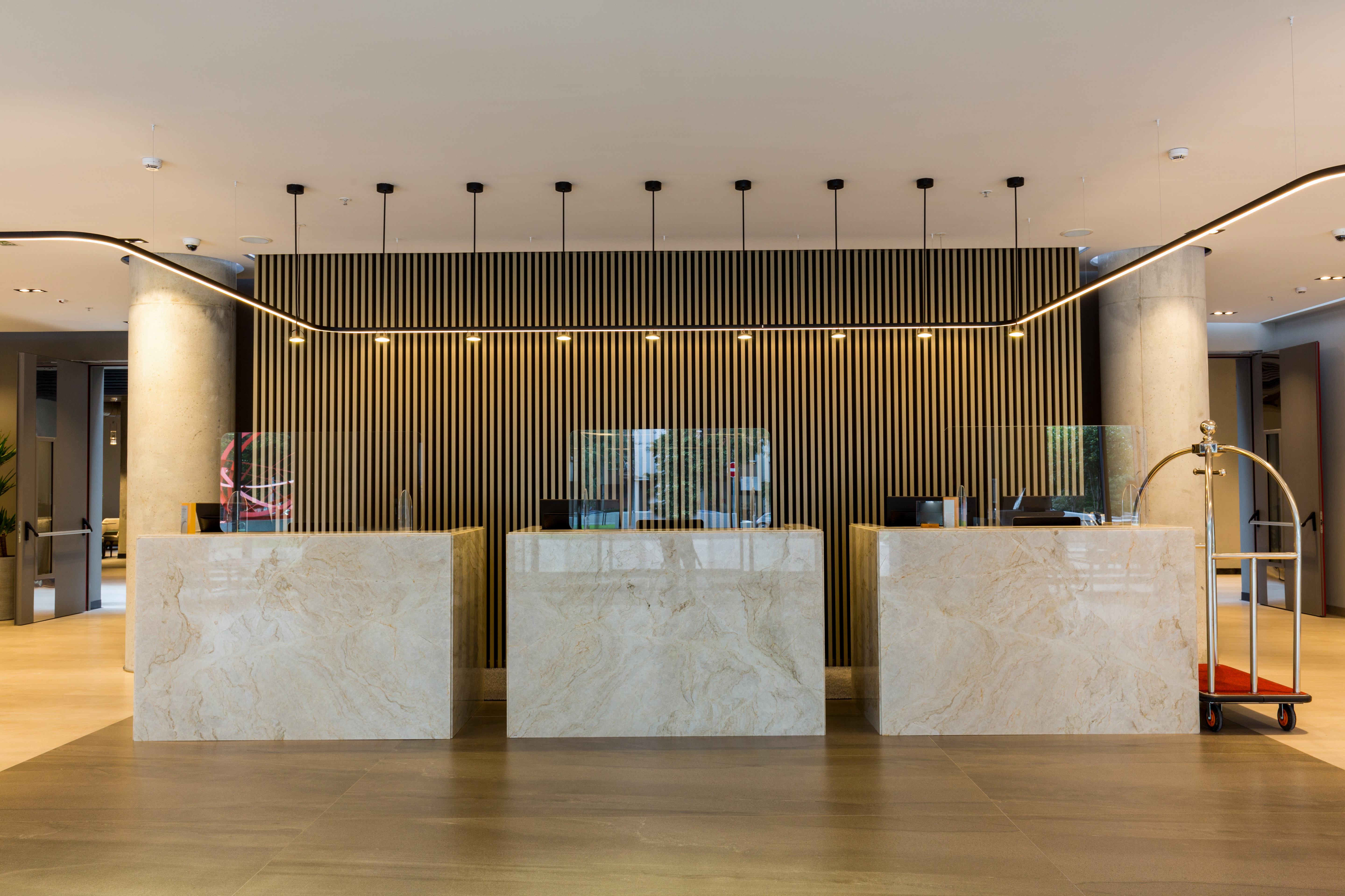 Interior of a hotel lobby with reception desks. | Source: Shutterstock