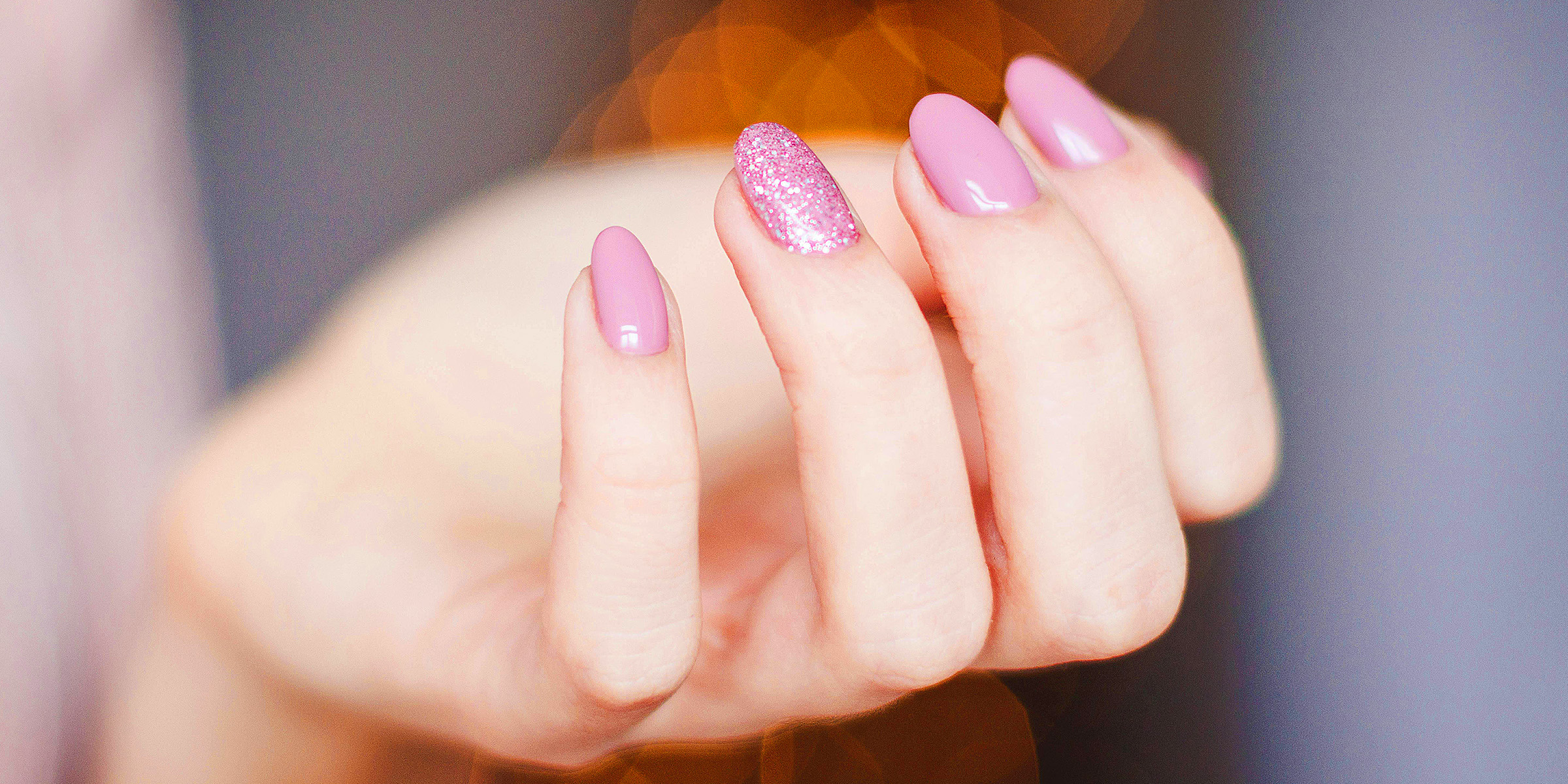 A person's fingers with pink nail polish | Source: Pexels