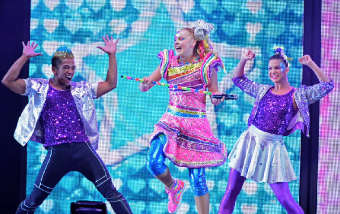 JoJo Siwa performs with her background dancers  at Honda Center, on August 13, 2019, in Anaheim, California | Source: Michael Tullberg/Getty Images