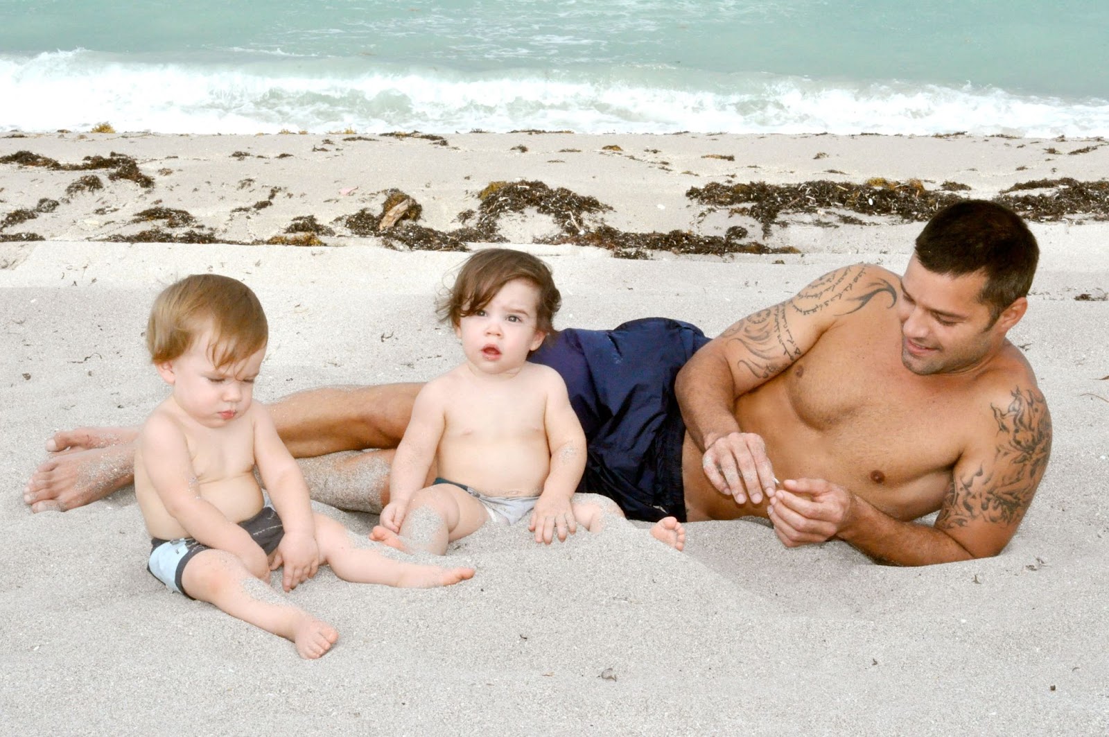 Ricky Martin shared a playful beach day with his twins. The family enjoyed the simple joy of sun and sand, marking an early memory in Ricky’s journey as a dedicated dad. | Source: Getty Images