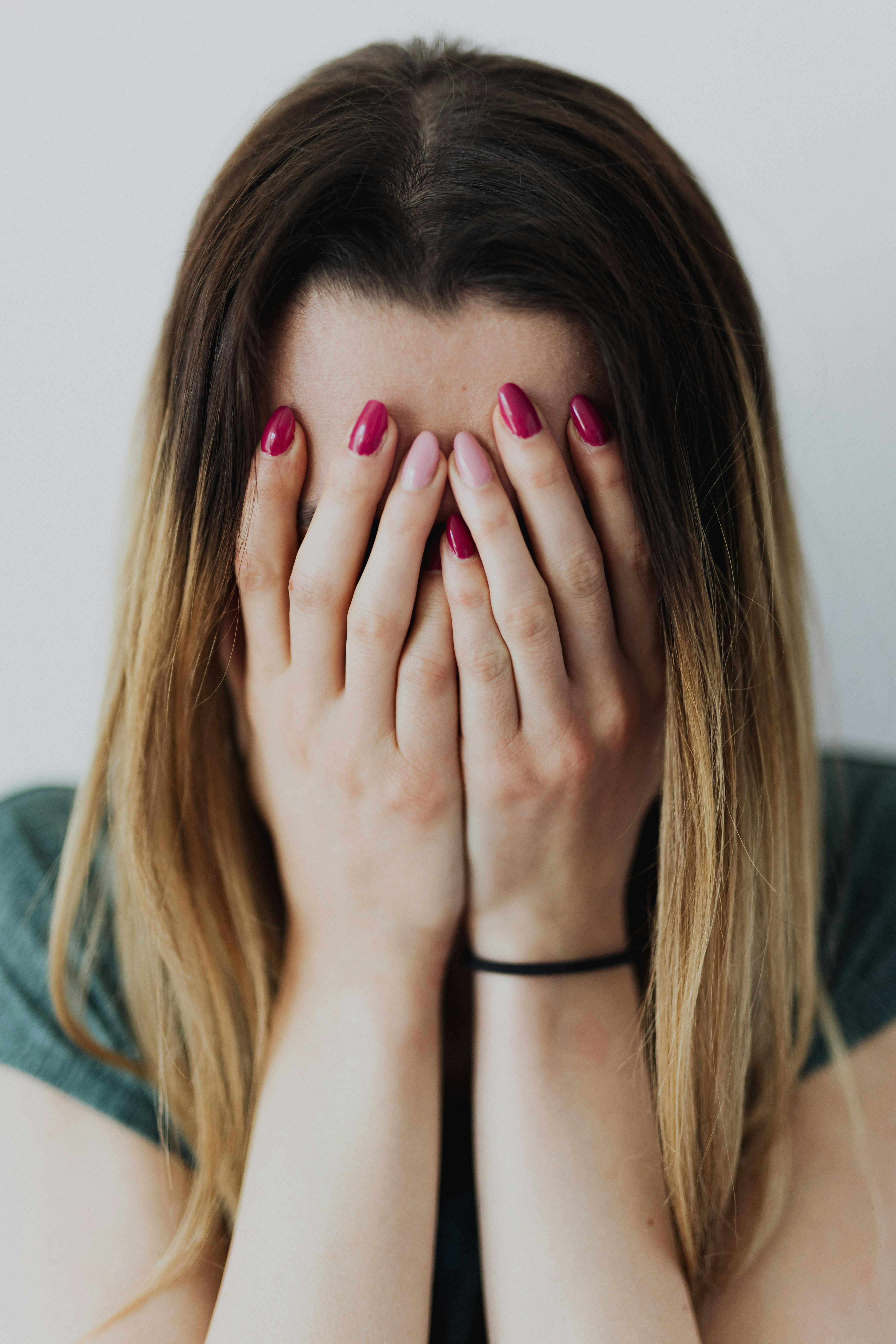 A woman covering her face | Source: Pexels