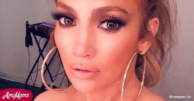 Jennifer Lopez flashes abs and legs while dressed in leggings with her face on them