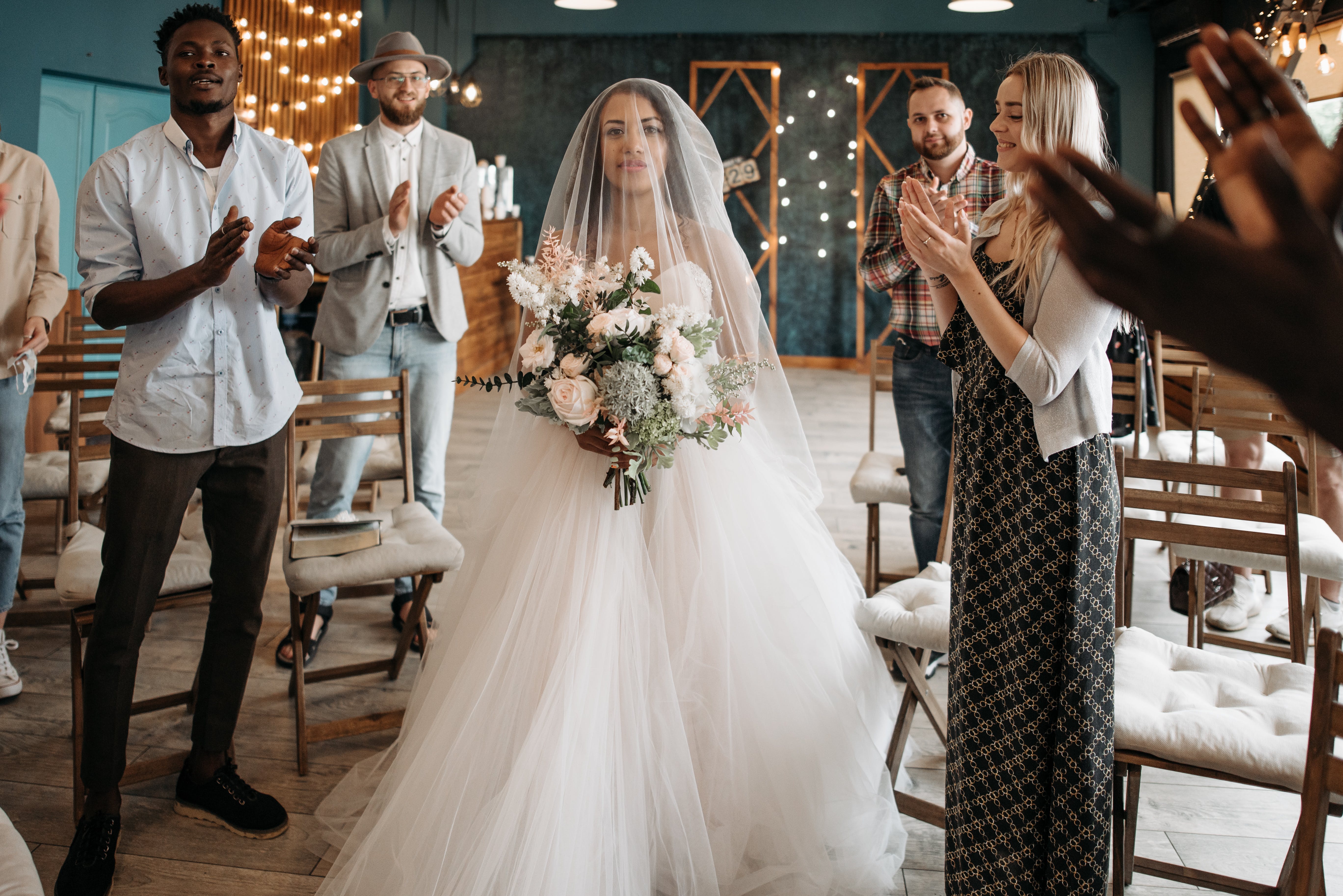 Guests clapping their hands and standing for the bride | Source: Pexels