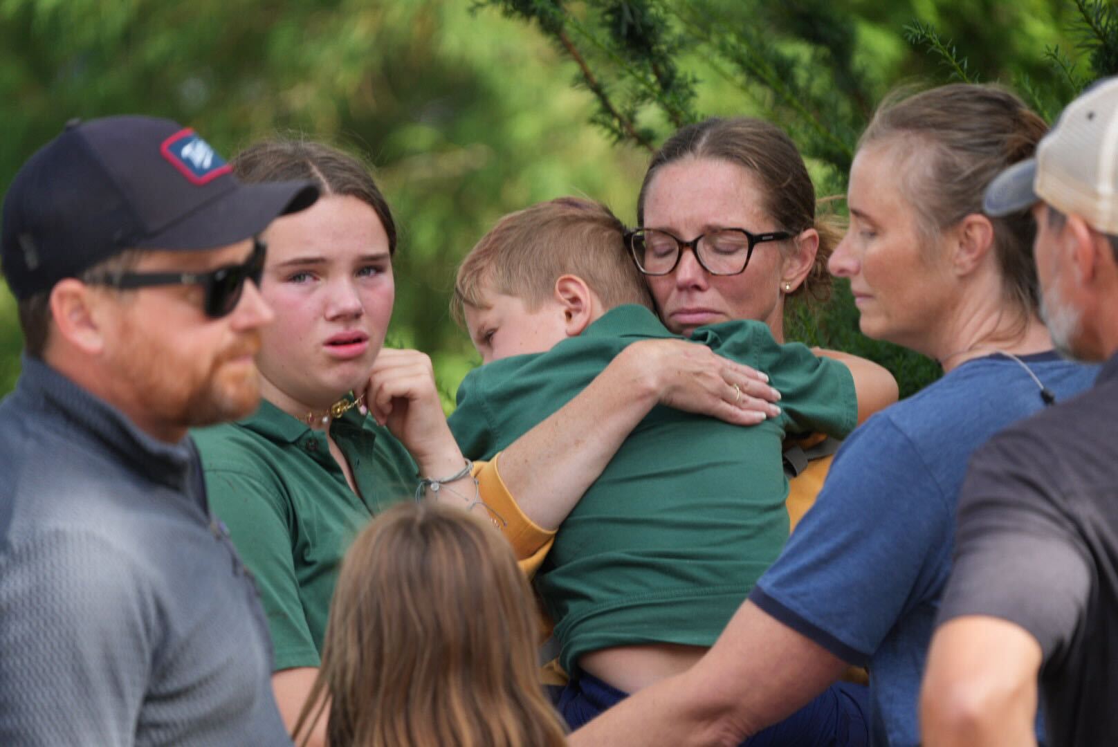Families comfort one another near Annunciation Church following the deadly shooting in Minneapolis on August 27, 2025 | Source: Getty Images