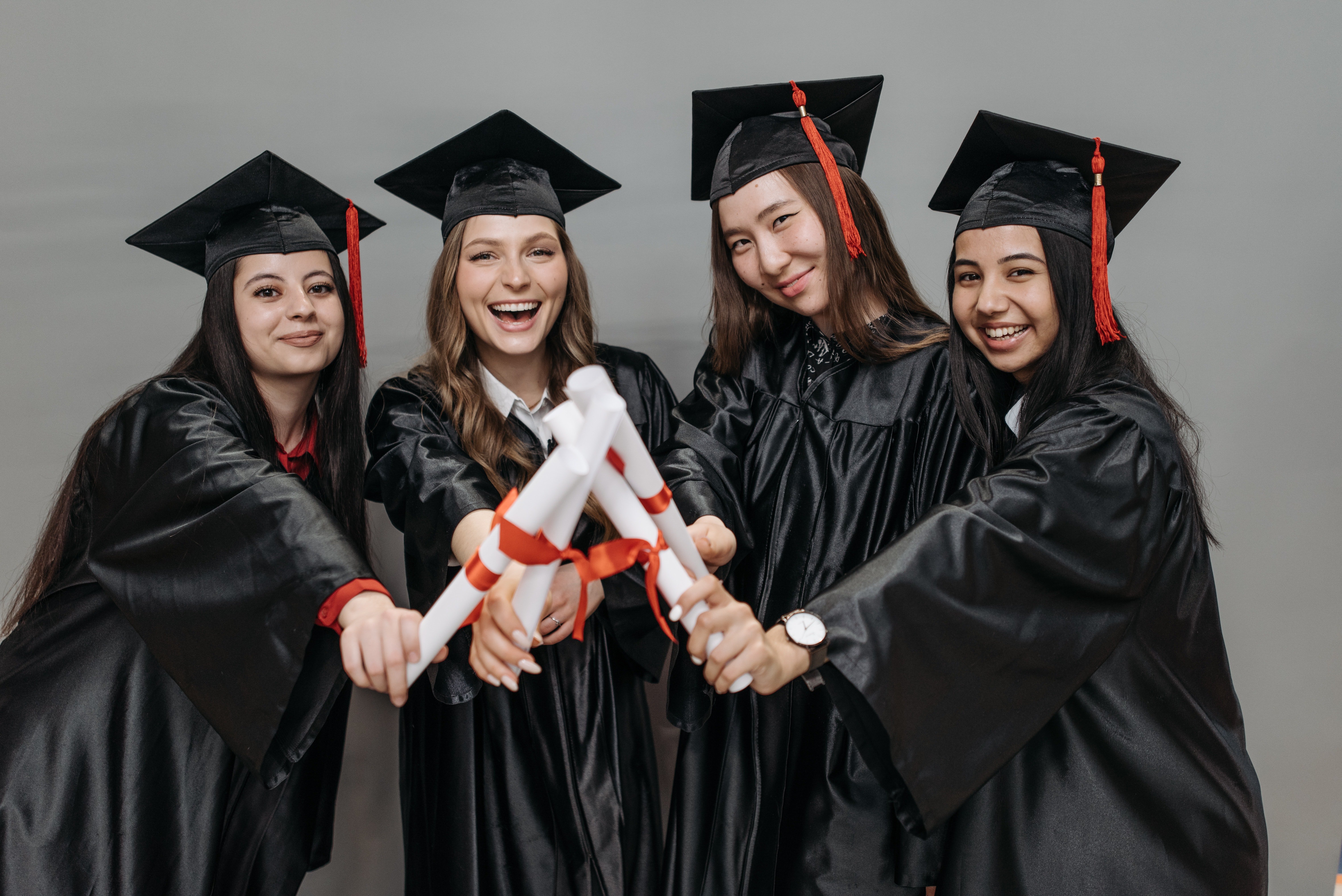 Women holding their diplomas | Source: Pexels
