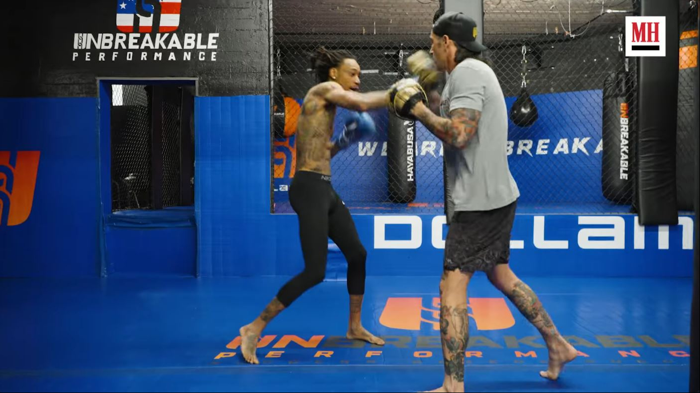 Wiz Khalifa practices striking combinations while training with a coach inside the gym. | Source: YouTube/Men's Health